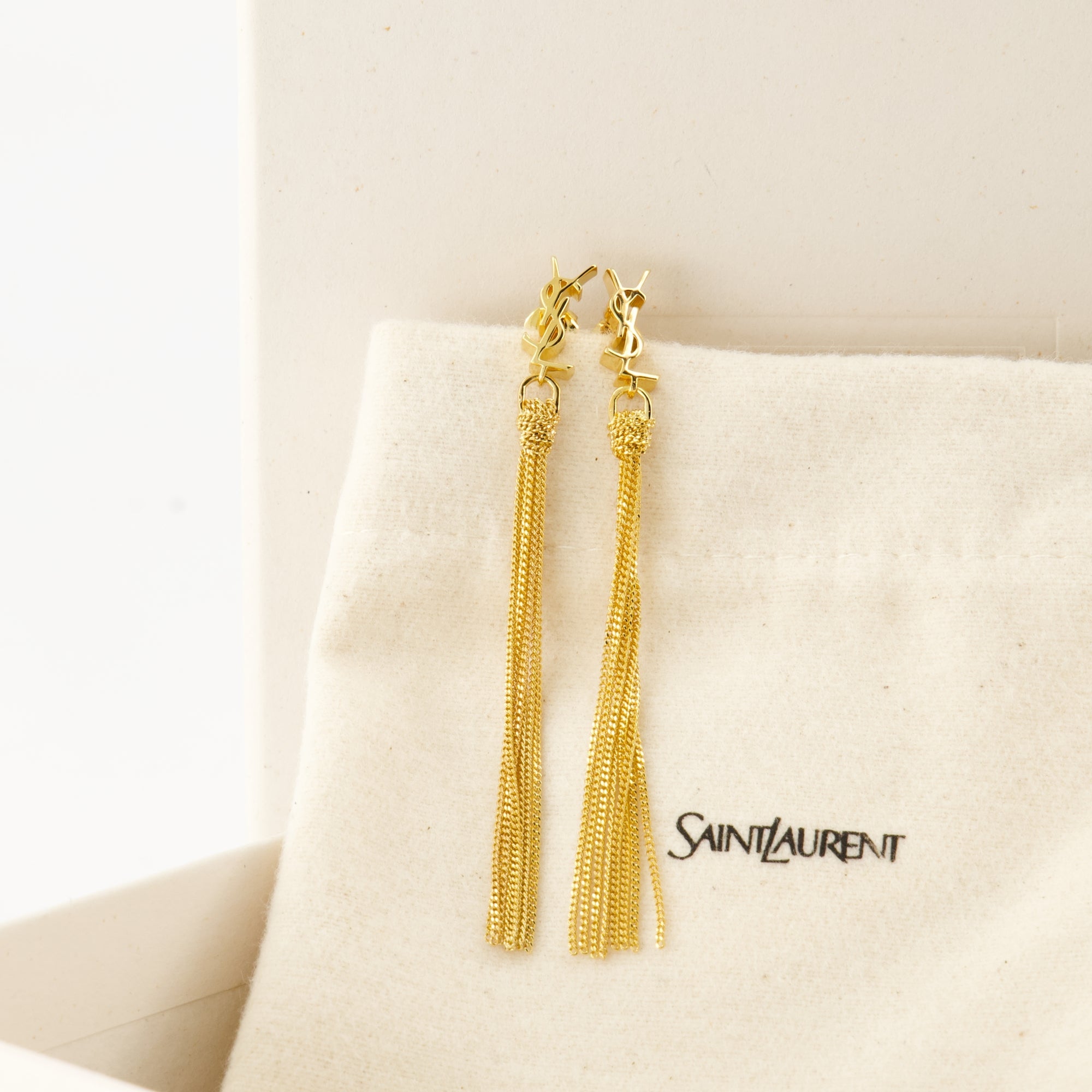 Cassandre earrings, Saint Laurent jewelry, gold earrings, elegant accessories, brass earrings