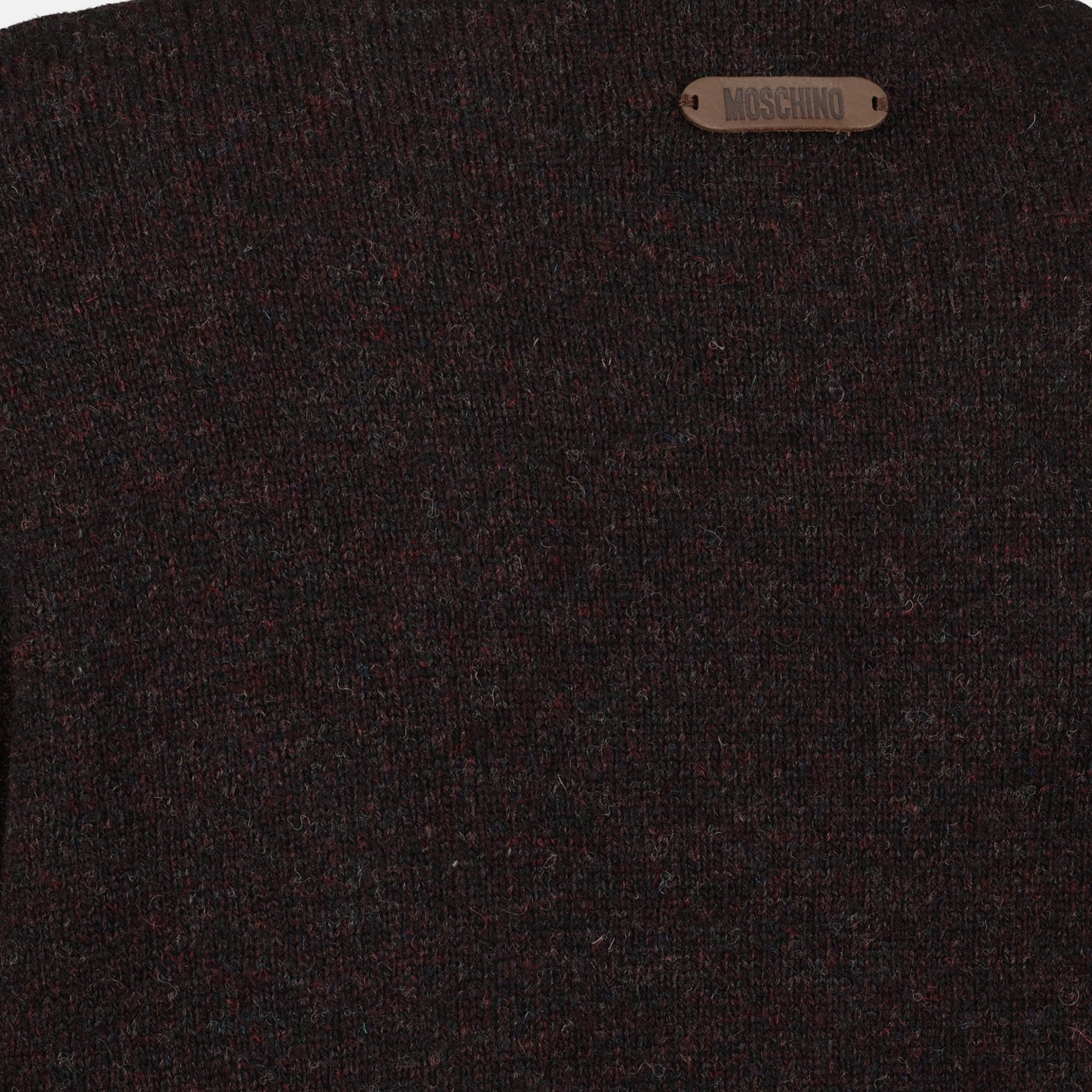 brown wool sweater, Moschino fashion, Fall-Winter 2025 collection, distressed effect clothing, luxury knitwear