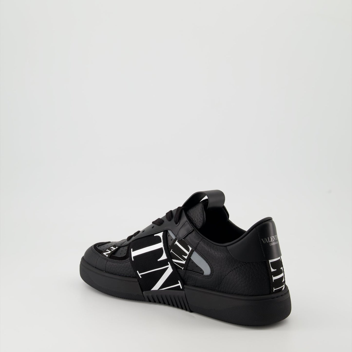 Valentino Garavani sneakers, black leather sneakers, luxury men's footwear, Autumn-Winter 2024 collection, premium grained leather