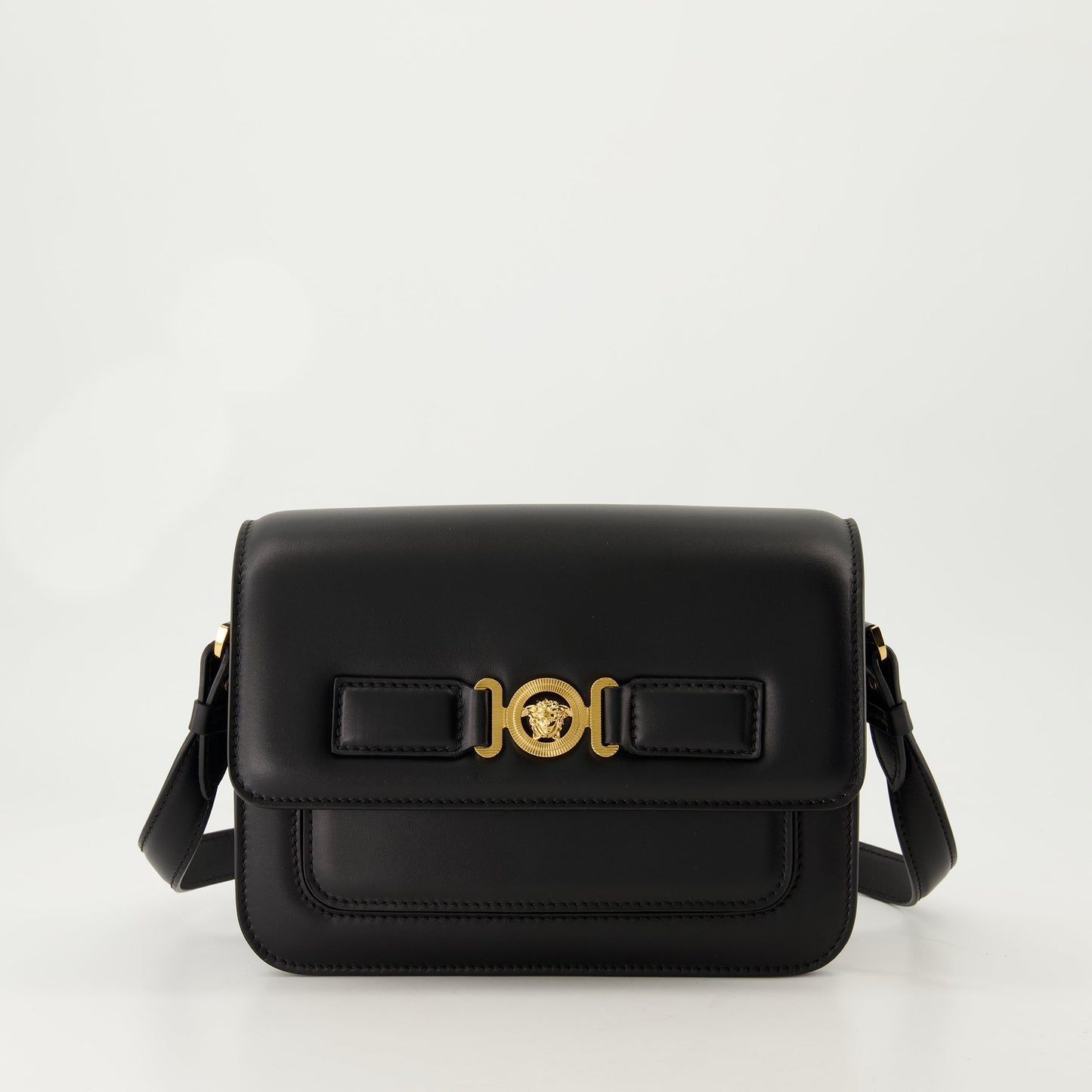 leather satchel, adjustable strap, embossed logo, black bag, Medusa accents