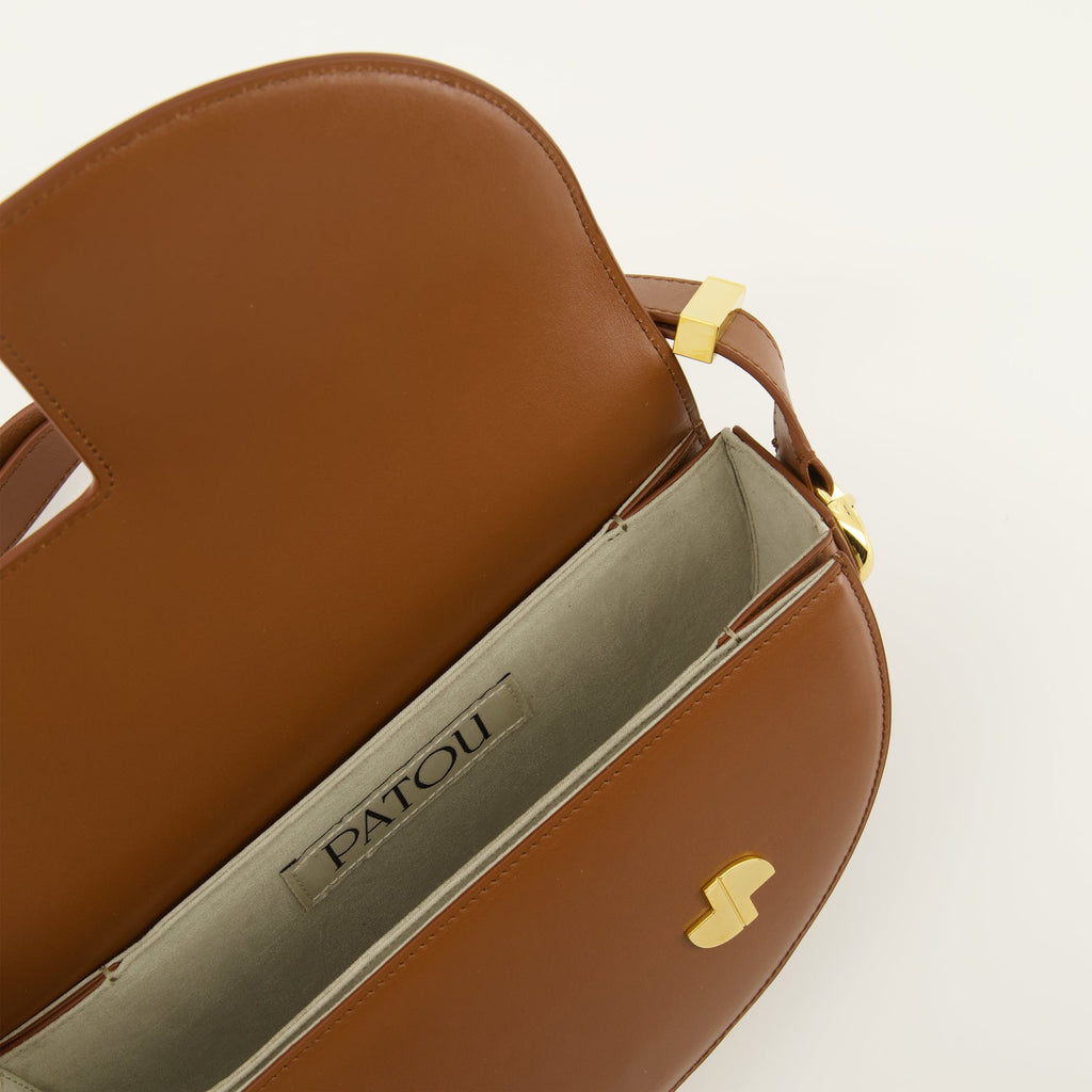 brown handbag, Patou handbag, leather shoulder bag, semi-circular bag, chic bag