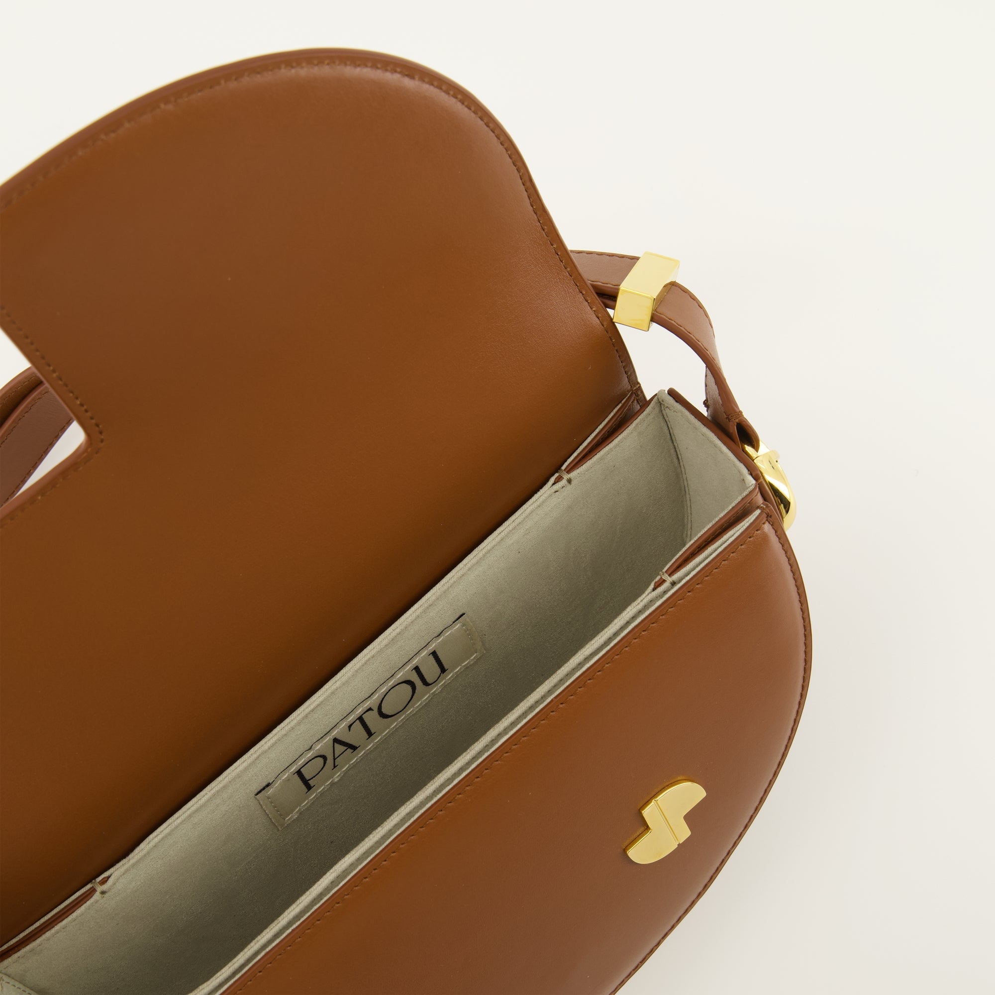 brown handbag, Patou handbag, leather shoulder bag, semi-circular bag, chic bag