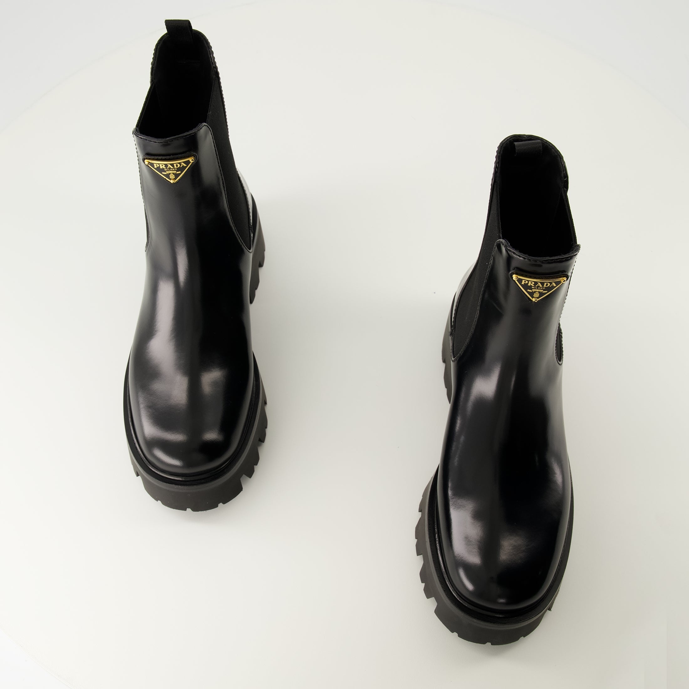 Prada ankle boots, black leather boots, Autumn-Winter 2025, slip-on design, rubber tread sole