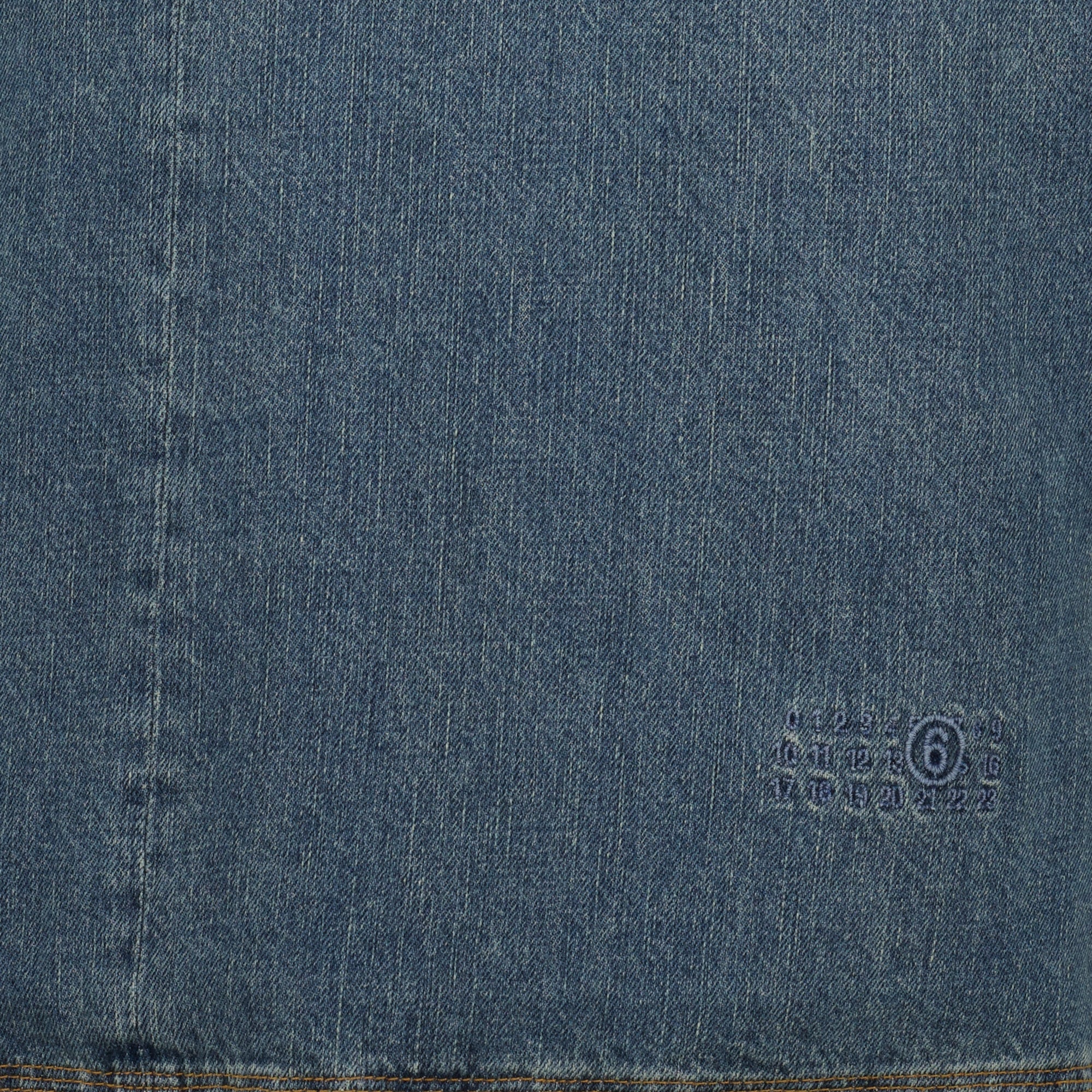 denim vest, V-neck design, sleeveless clothing, embroidered logo, light blue denim