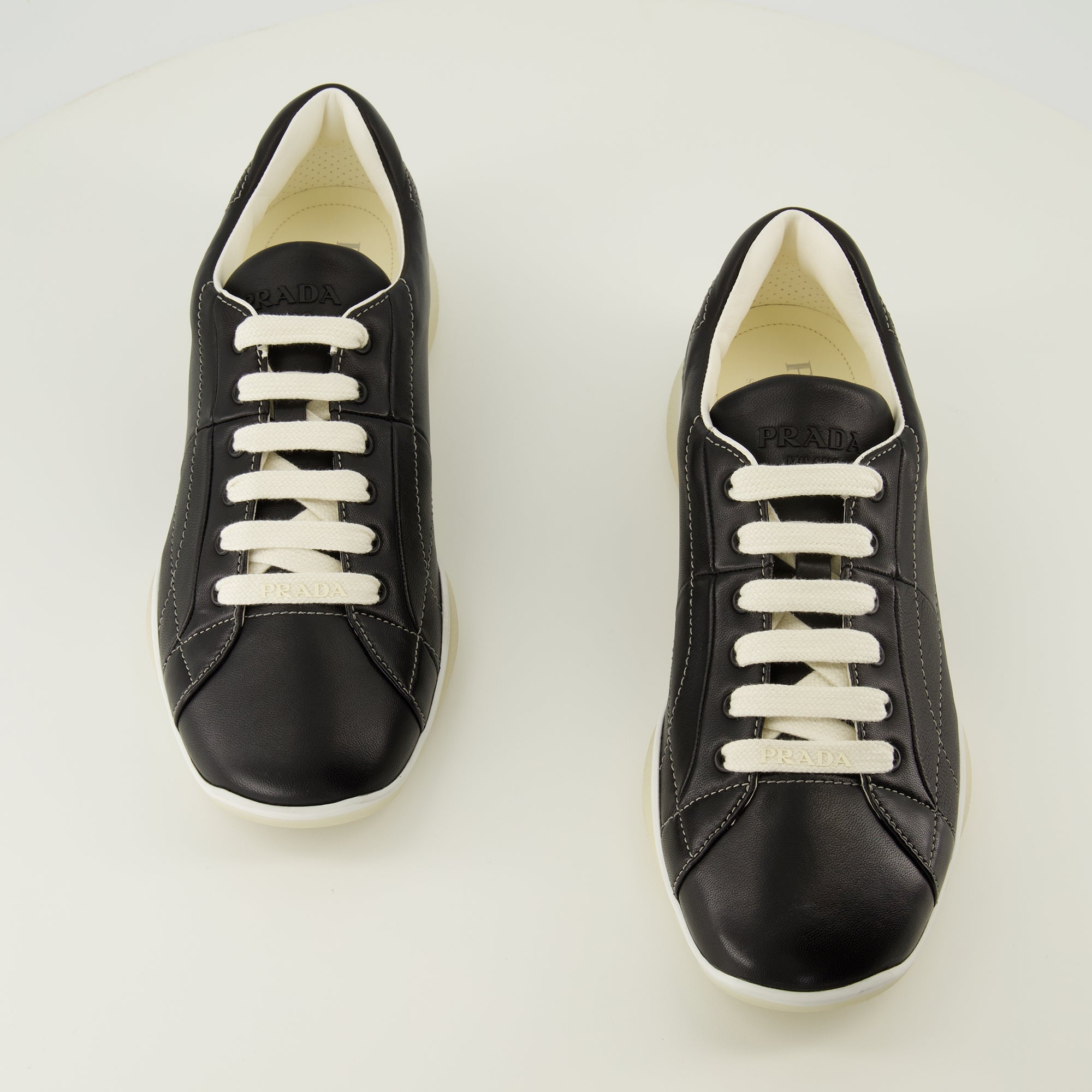 Prada sneakers, black leather footwear, comfort sneakers, rubber sole shoes, stylish lace-up shoes