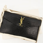Uptown pouch, crocodile-effect accessory, Saint Laurent pouch, black leather pouch, Autumn-Winter 2025 collection