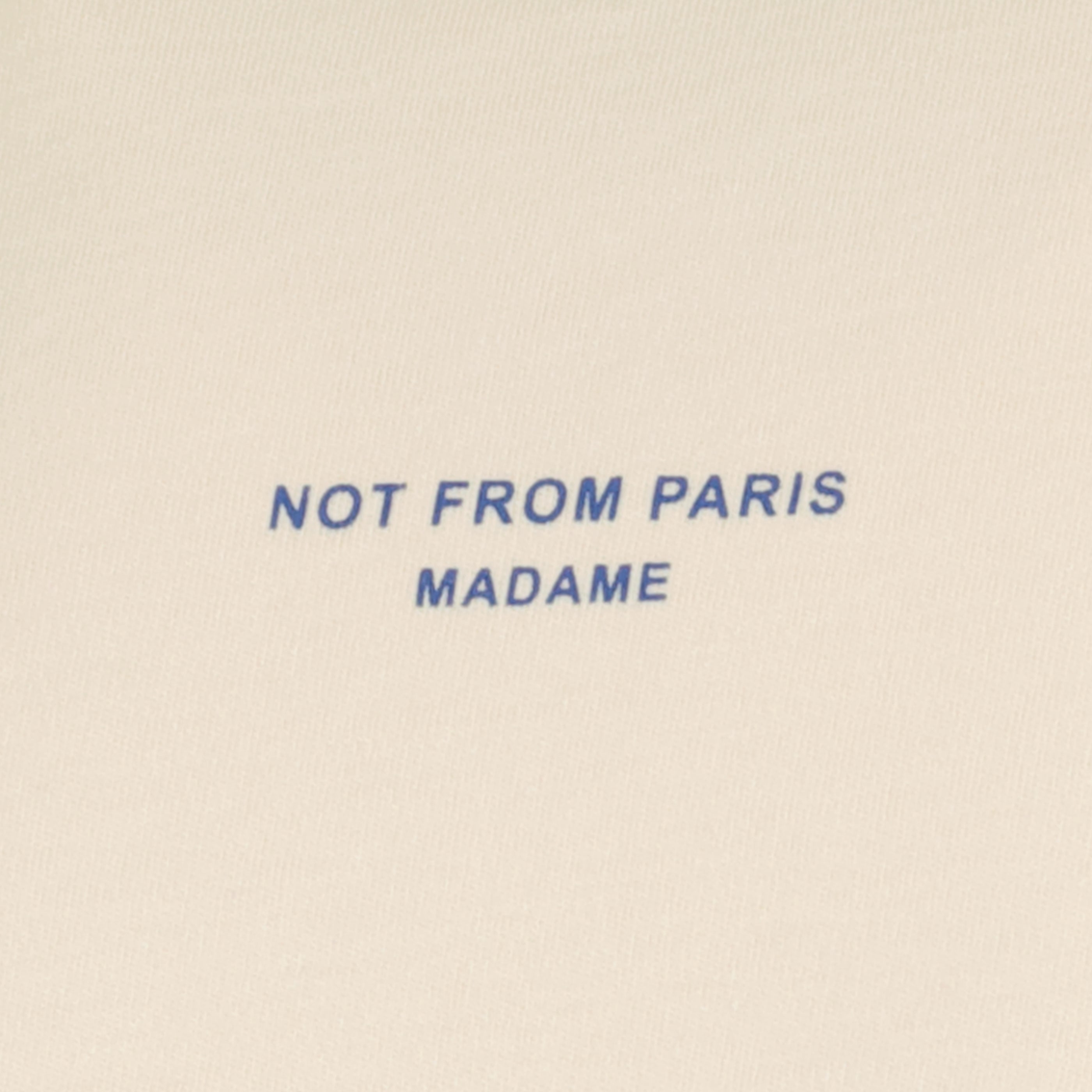 ベージュ Tシャツ スローガン「Not from Paris Madame」