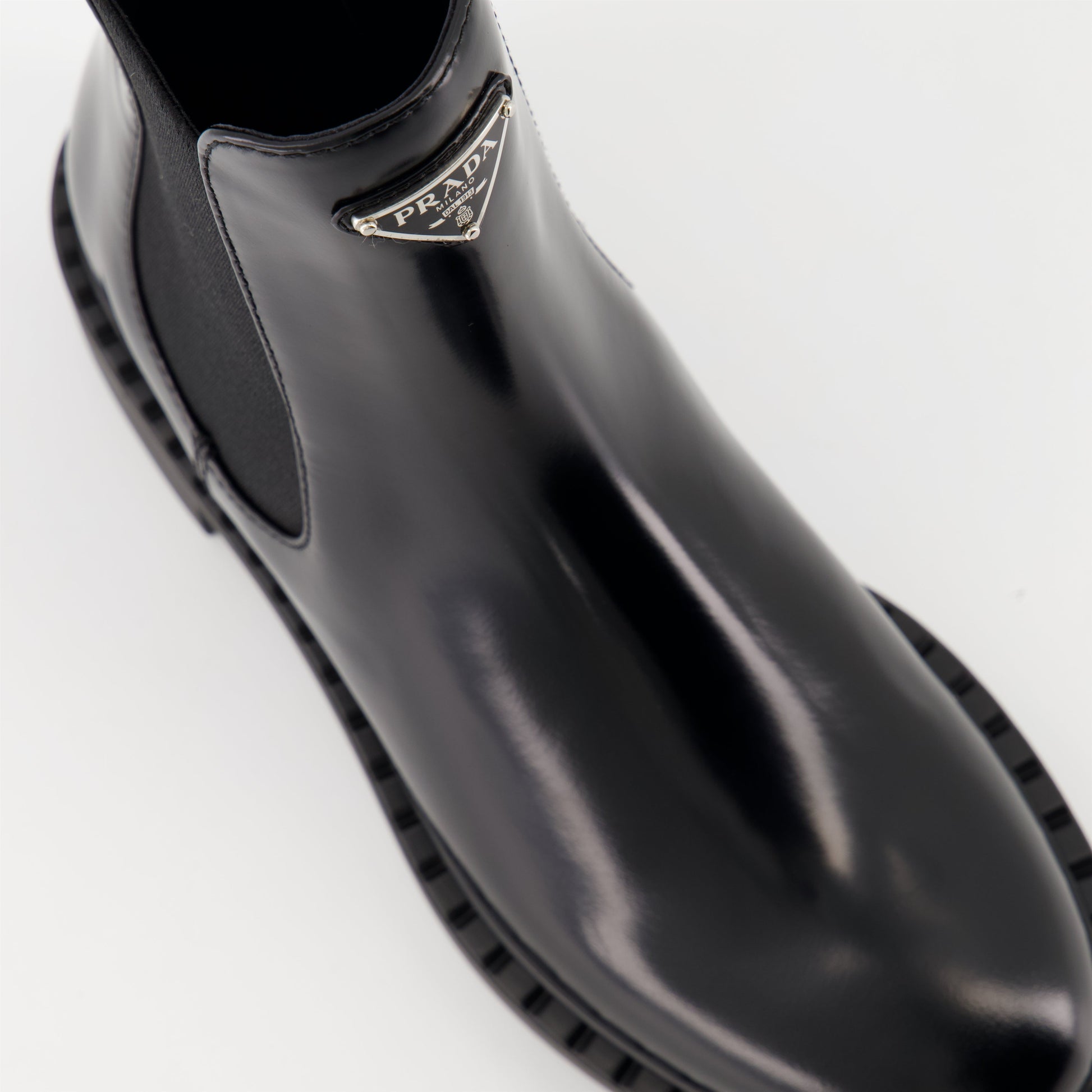   Patent leather boots, Prada ankle boots, black patent shoes, luxury footwear, autumn-winter collection.