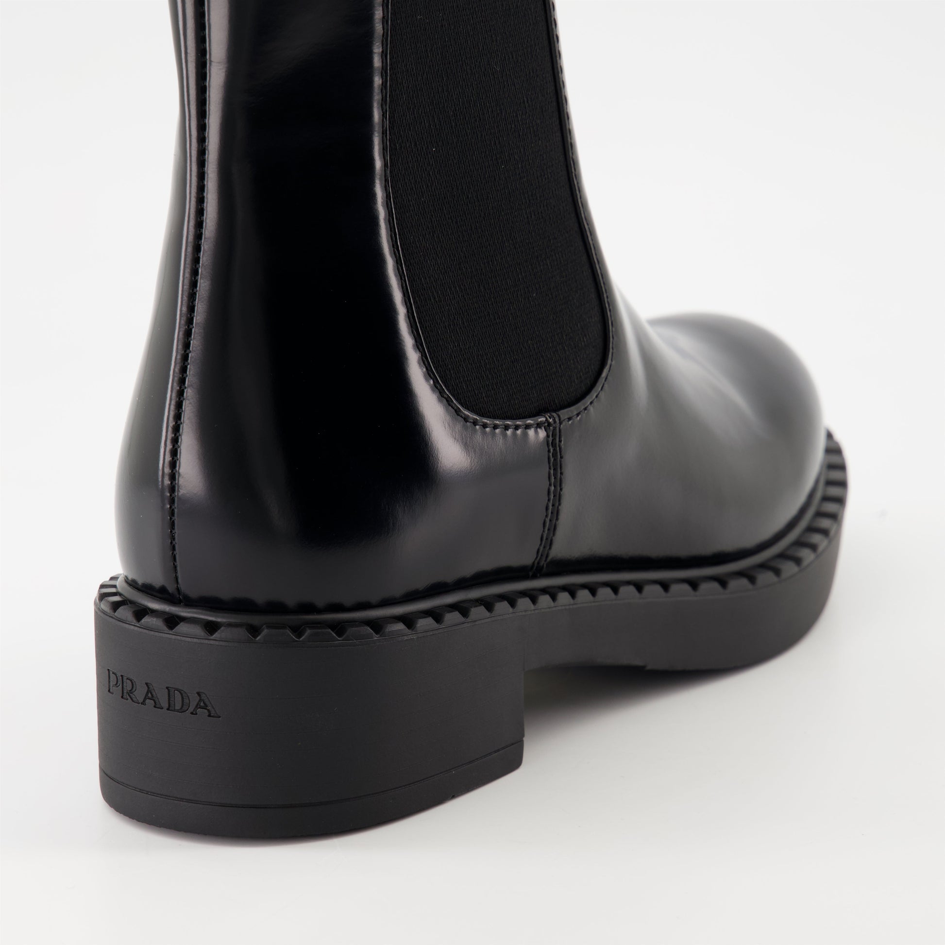   Patent leather boots, Prada ankle boots, black patent shoes, luxury footwear, autumn-winter collection.