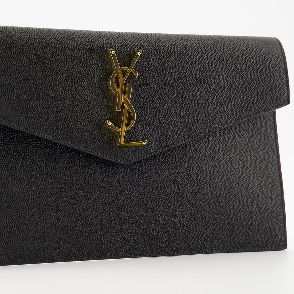 black pouch, grained leather, magnetic closure, Saint Laurent, Cassandre logo