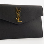 black pouch, grained leather, magnetic closure, Saint Laurent, Cassandre logo