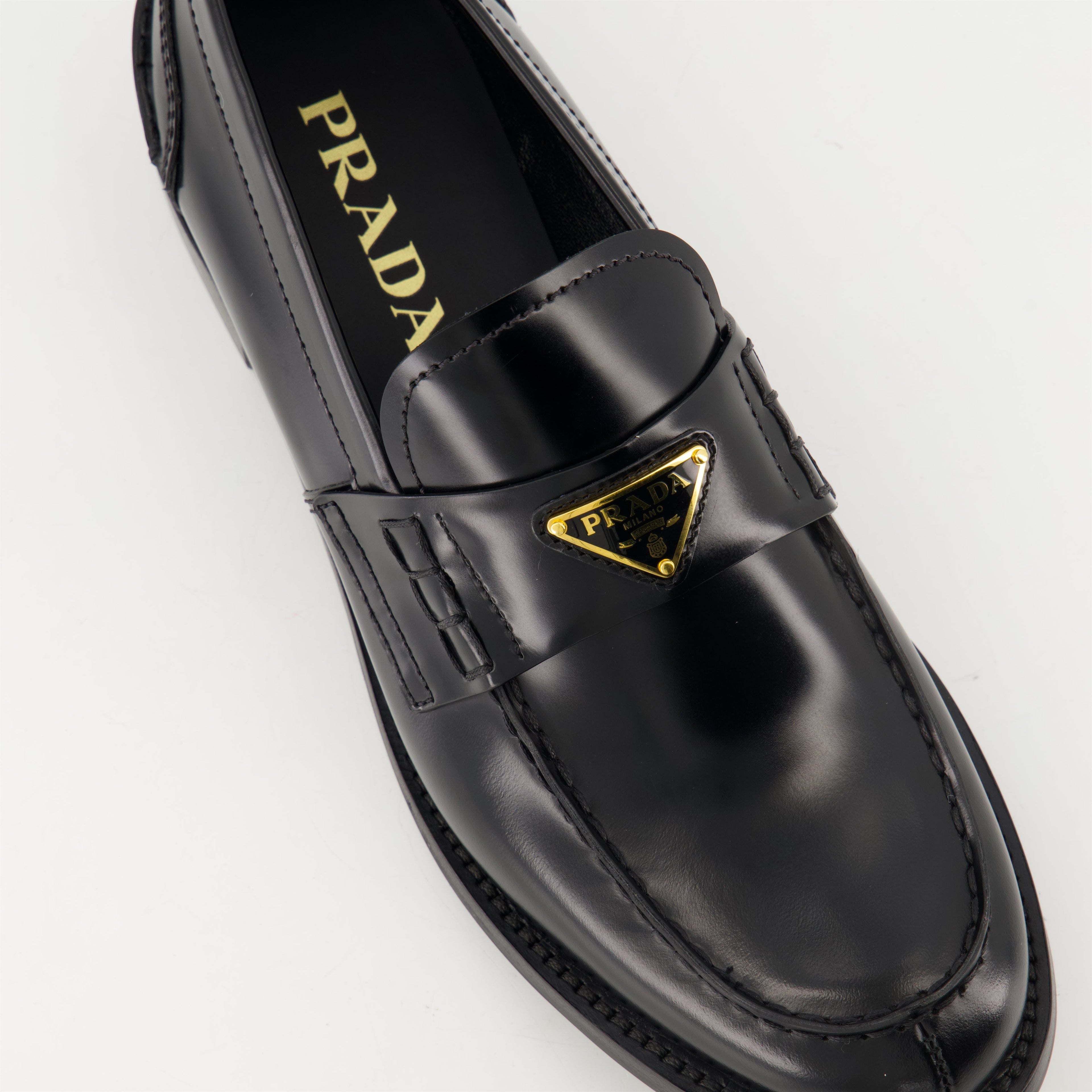 black leather moccasins, Prada footwear, brushed leather shoes, designer slip-ons, stylish moccasins