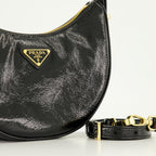 Image of Black Patent Leather Arque Bag by Prada for Women - Season Spring-Summer 2025 - Detail View 1