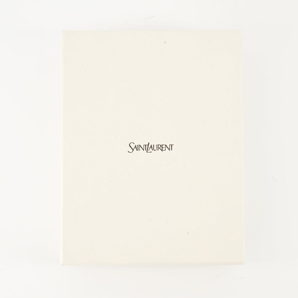 Cassandre envelope, Saint Laurent accessory, black leather bag, luxury clutch, grained leather