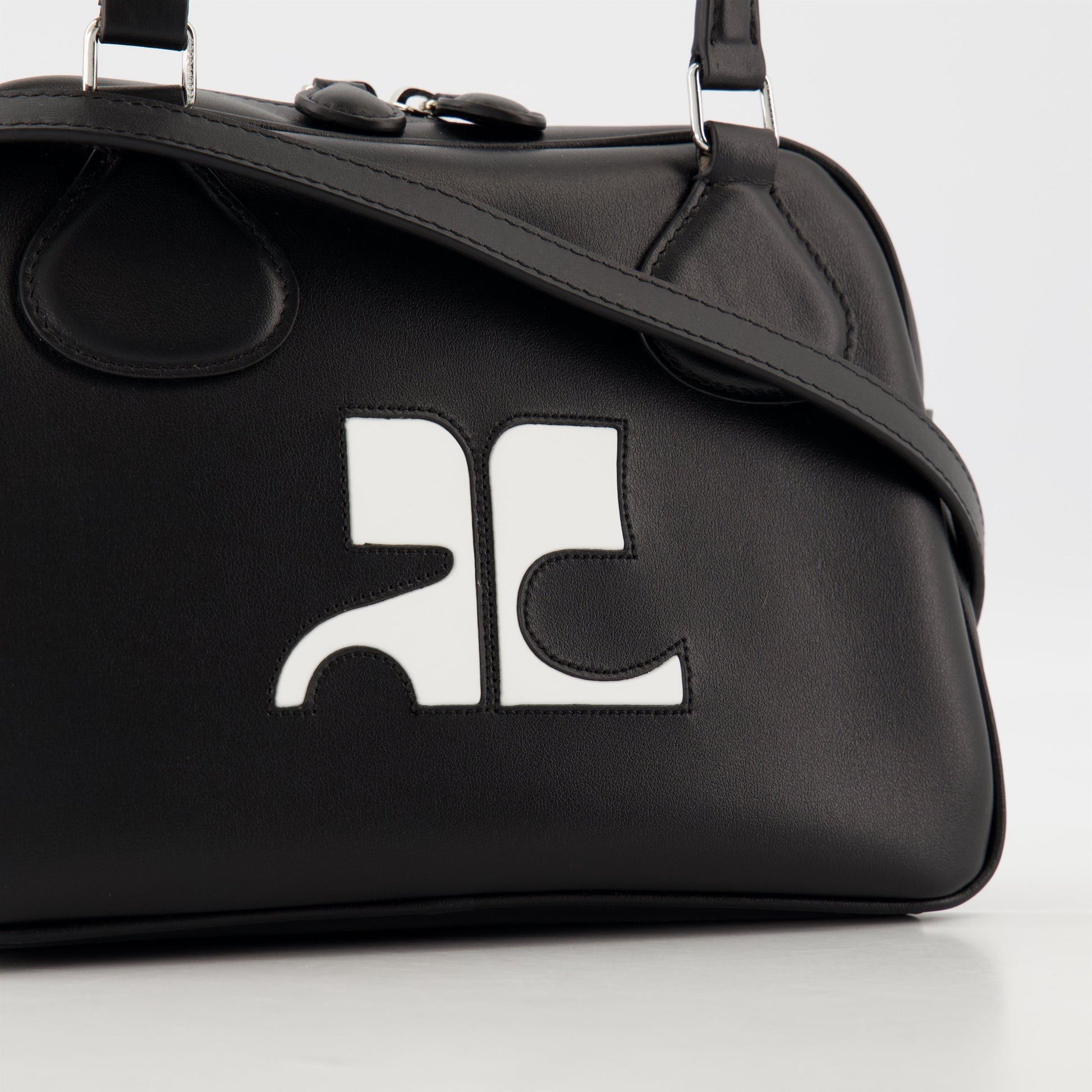 black leather bag, unisex bowling bag, Courrèges leather bag, luxury accessories, designer bags