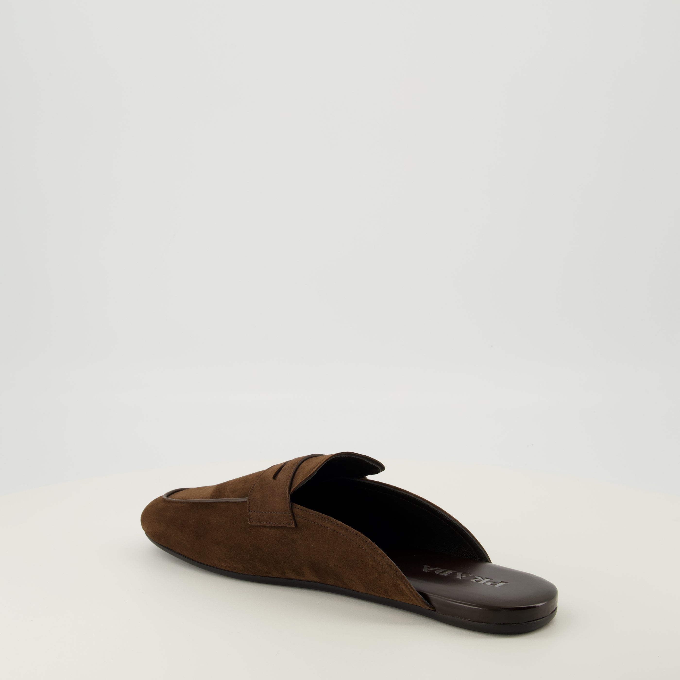 Image of Mules Mocassins en Cuir Suédé by Prada for Men - Season Spring-Summer 2026 - Back Right Three-Quarter View