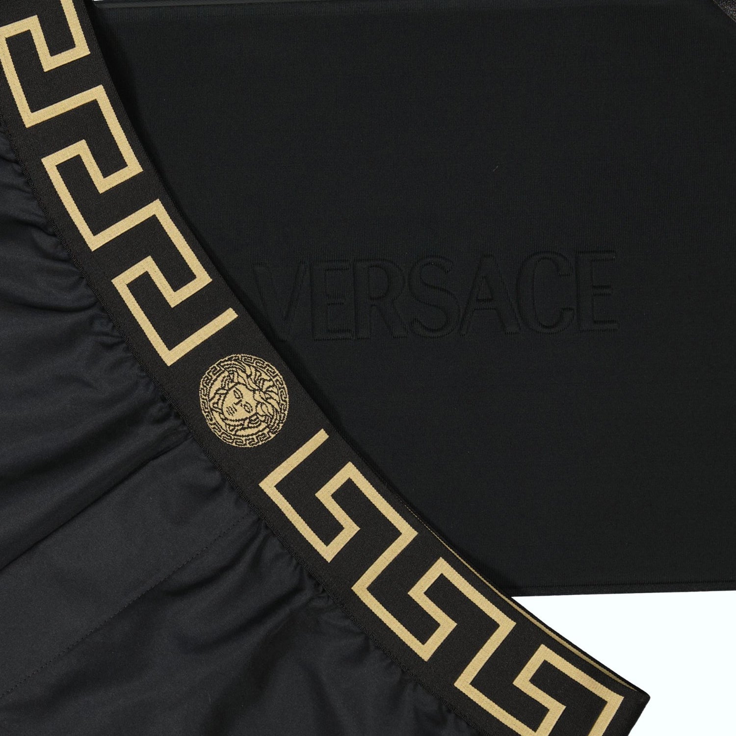 Greca swim shorts, Versace swimwear, black swim shorts, sustainable fashion, Medusa motif