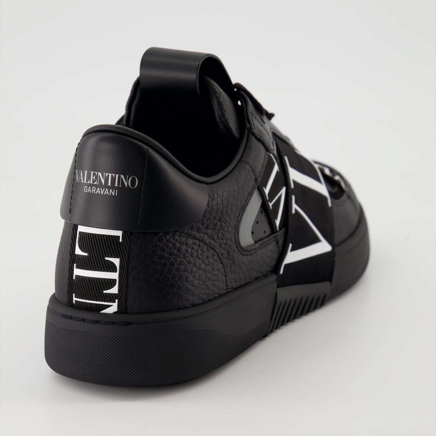 Valentino Garavani sneakers, black leather sneakers, luxury men's footwear, Autumn-Winter 2024 collection, premium grained leather