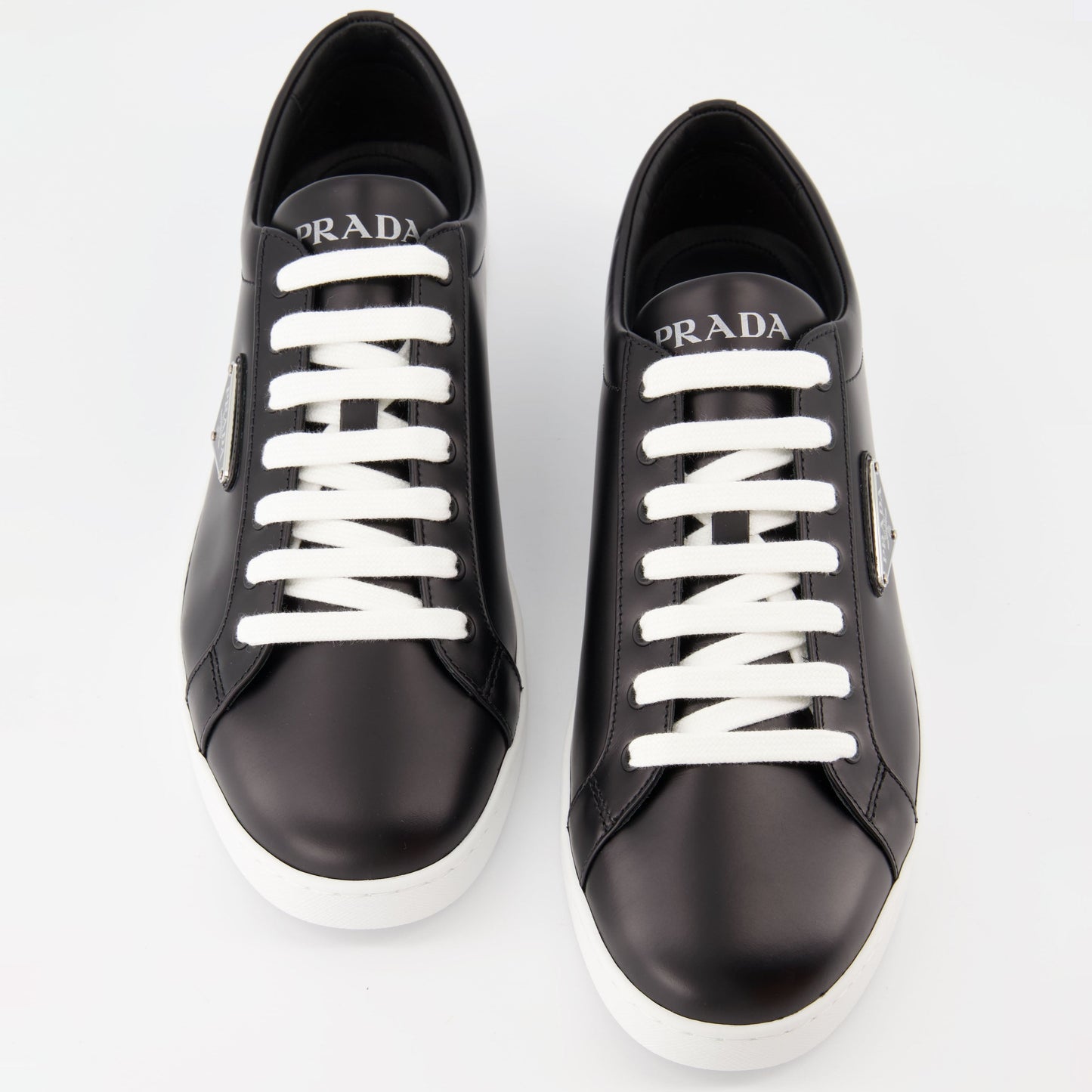 black leather sneakers, elegant footwear, men's sneaker style, contrast sole design, signature logo sneakers