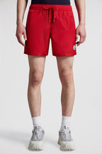red logo swim shorts, Moncler swimwear, luxury swim shorts, designer swimwear, summer essentials