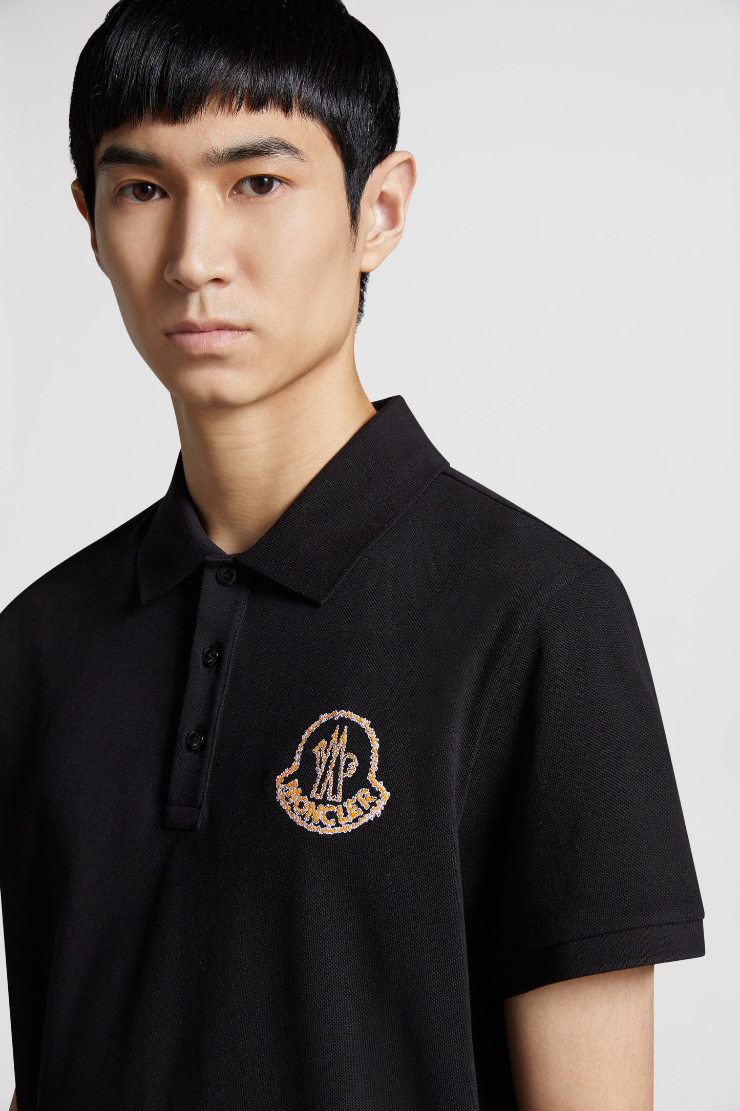 Moncler polo, black logo polo, luxury menswear, designer polo shirts, high-end fashion