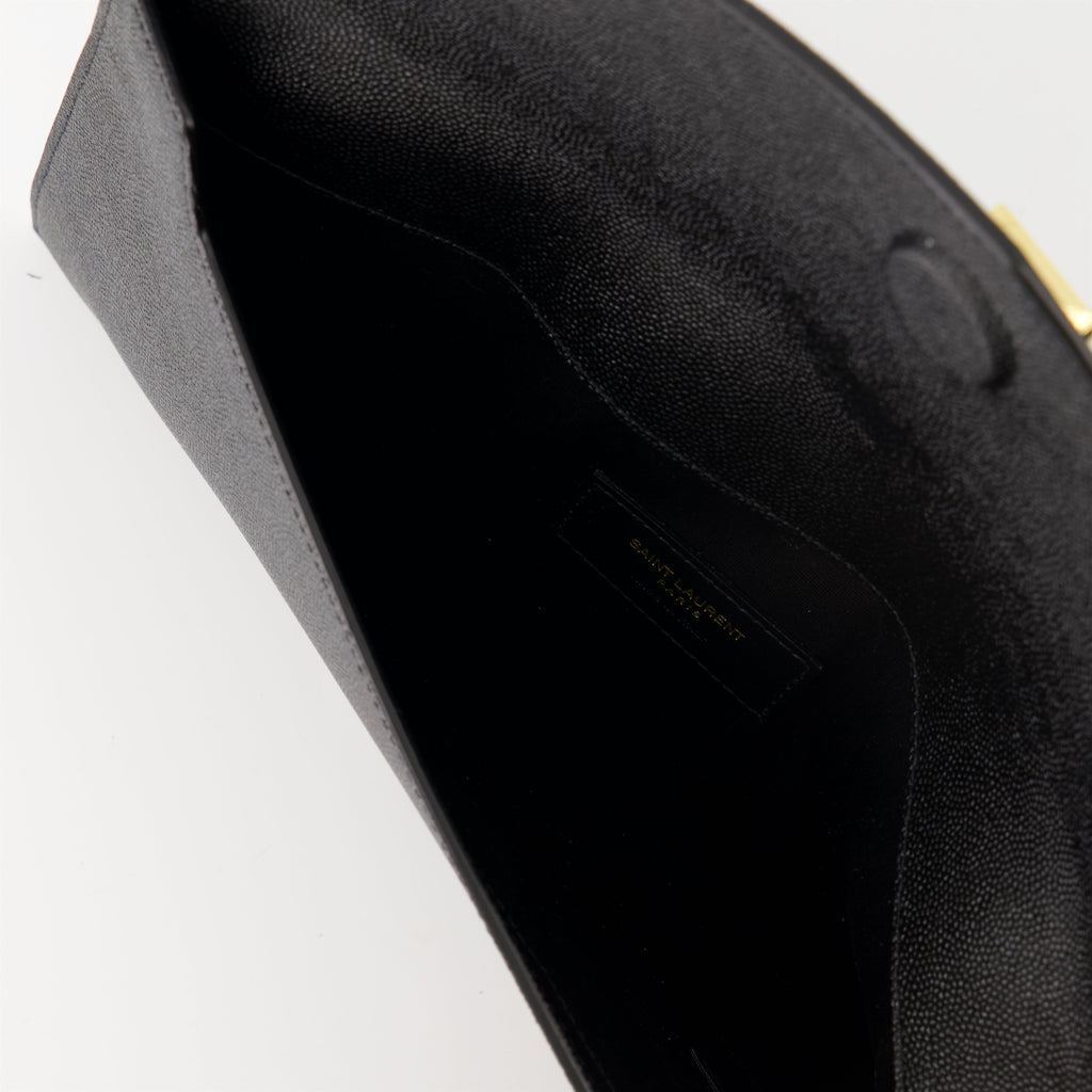 black pouch, grained leather, magnetic closure, Saint Laurent, Cassandre logo