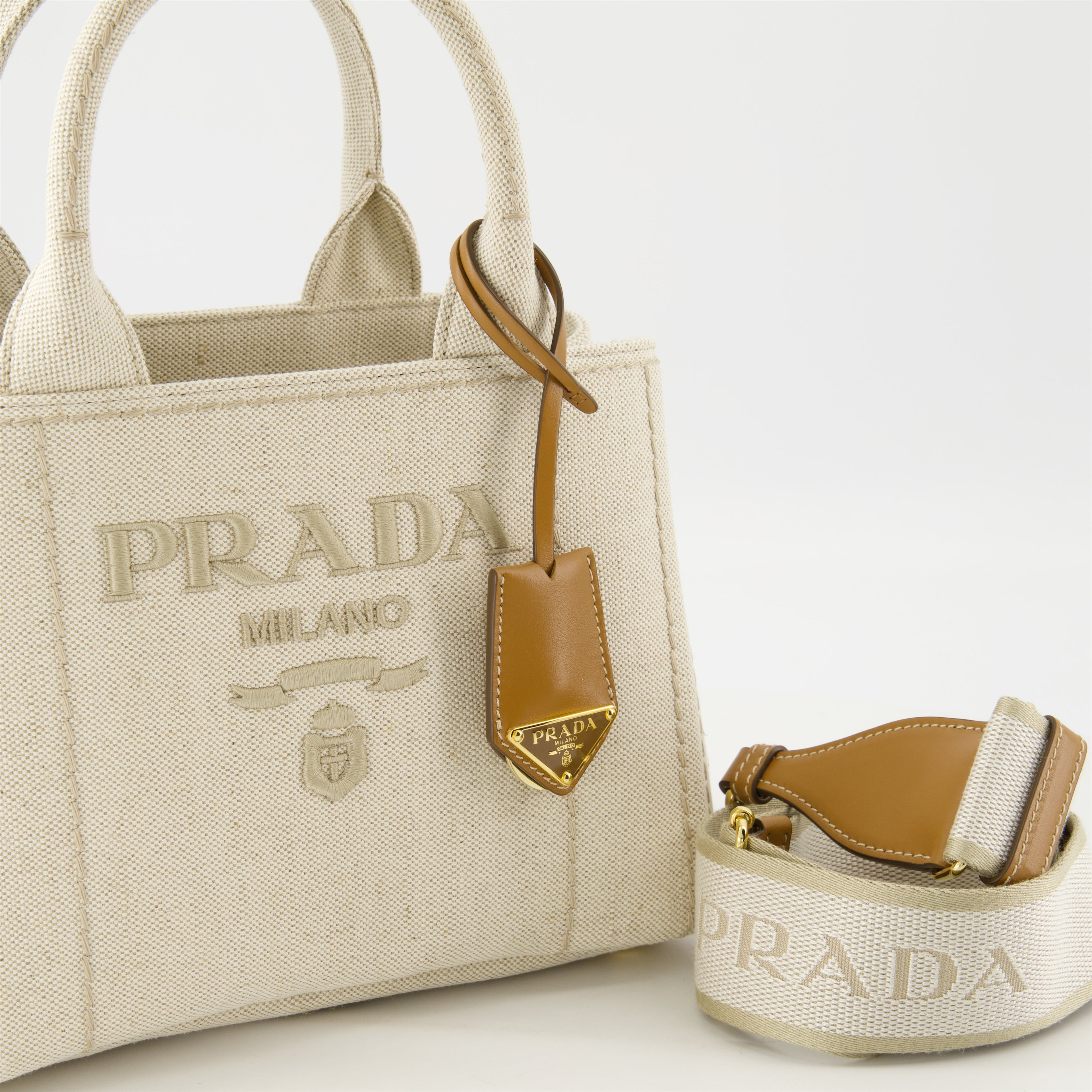 canvas tote bag, Prada, beige tote, luxury accessories, embroidered logo