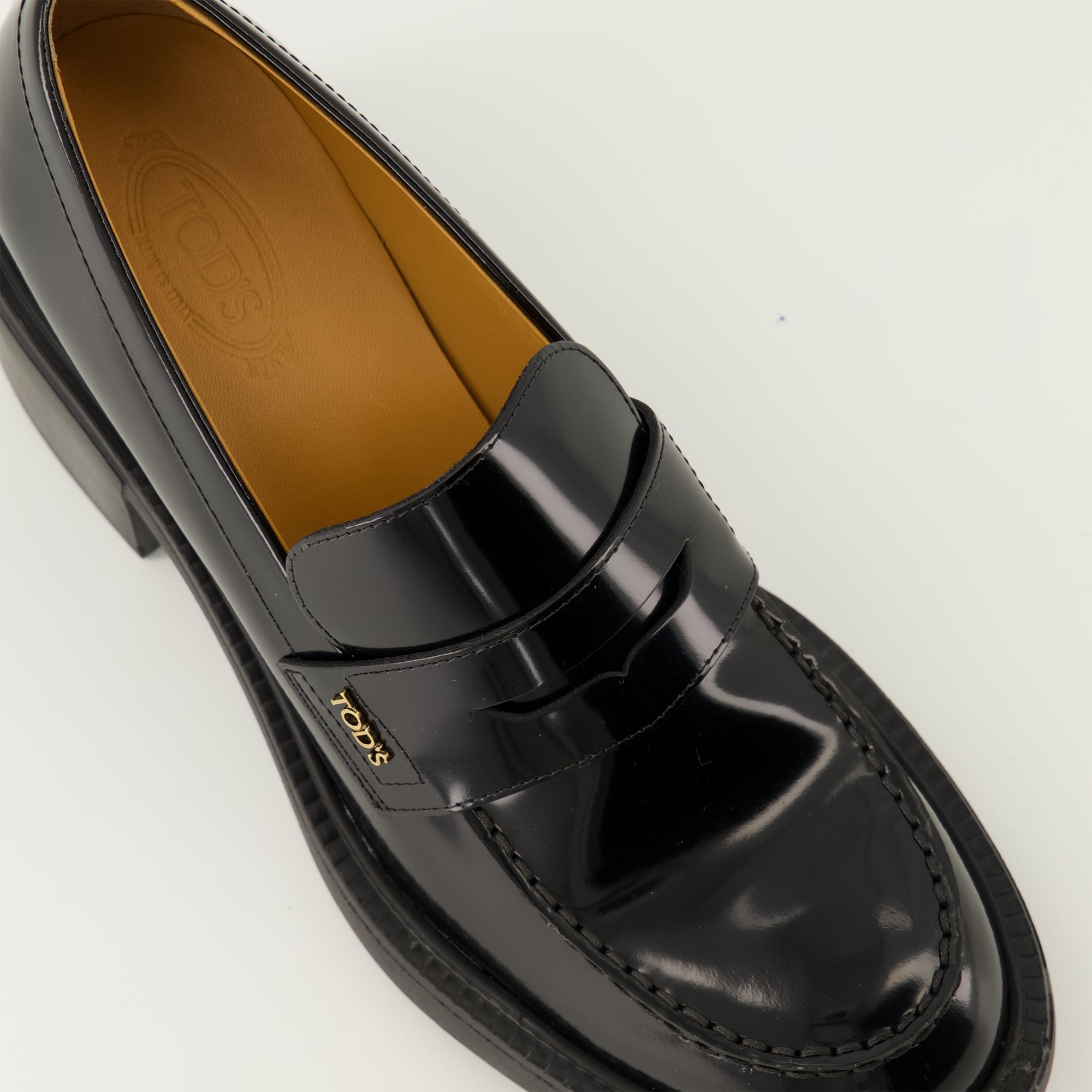 black leather moccasins, Tod's footwear, elegant slip-on shoes, autumn winter collection, women's moccasins