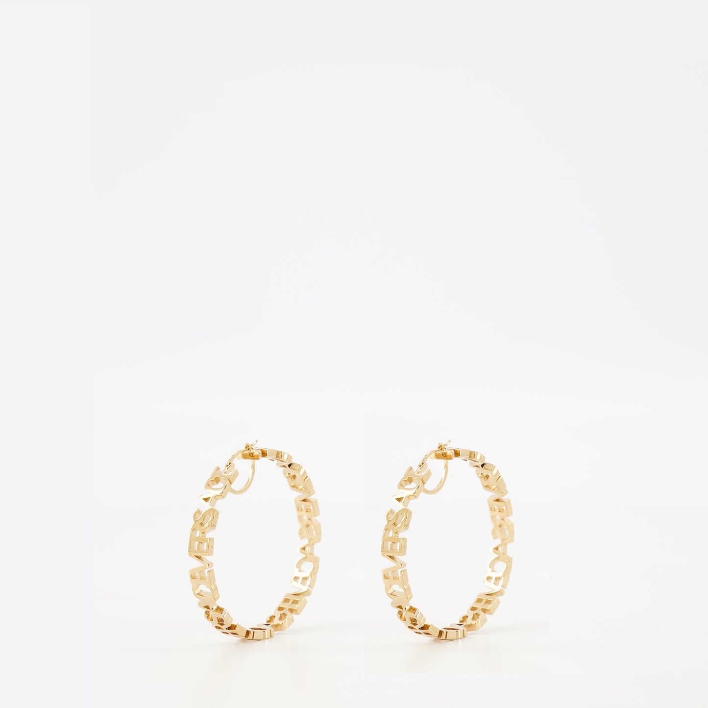 Gold hoop earrings, Versace jewelry, logo earrings, statement accessories, luxury earrings