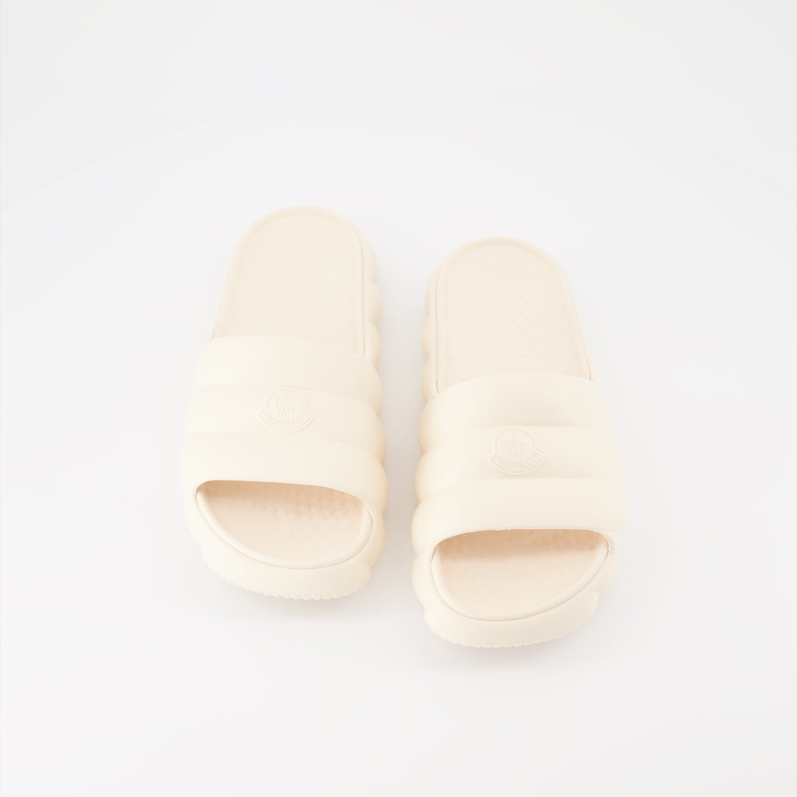 Moncler slides, luxury women's footwear, white slides, high-end fashion slides, designer casual shoes