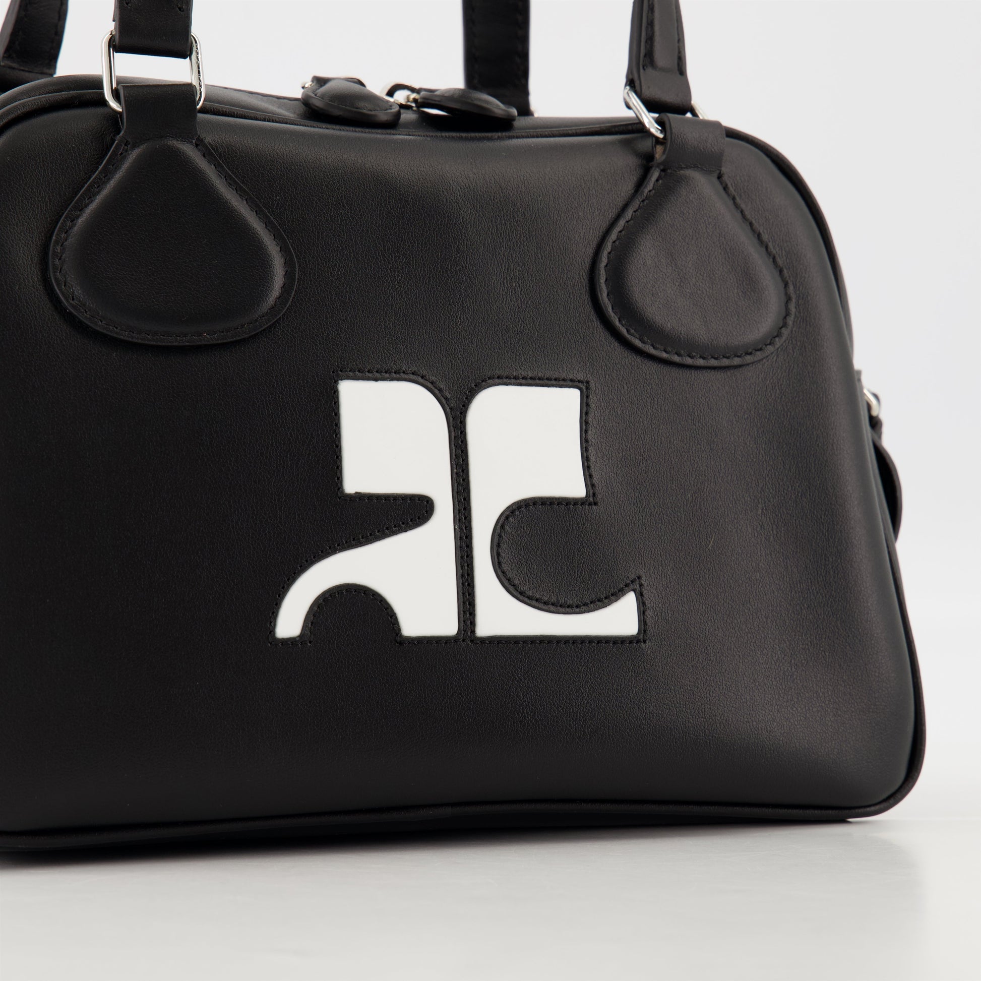 black leather bag, unisex bowling bag, Courrèges leather bag, luxury accessories, designer bags