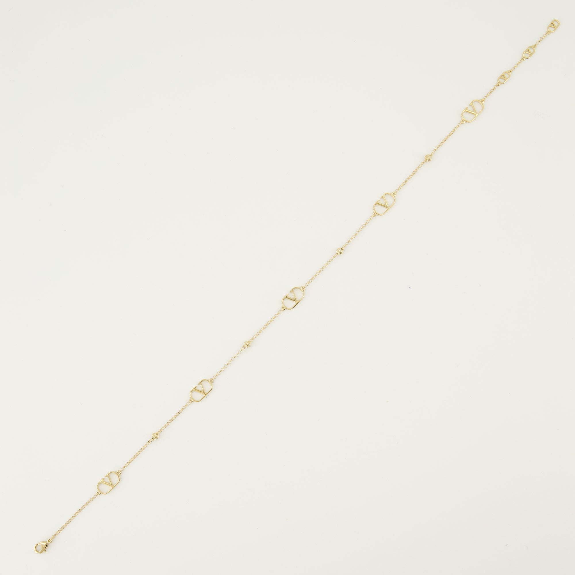 バレンティノ・ガラヴァーニの女性用Vlogoゴールドネックレスの画像 - 2026年春夏シーズン - 詳細ビュー1