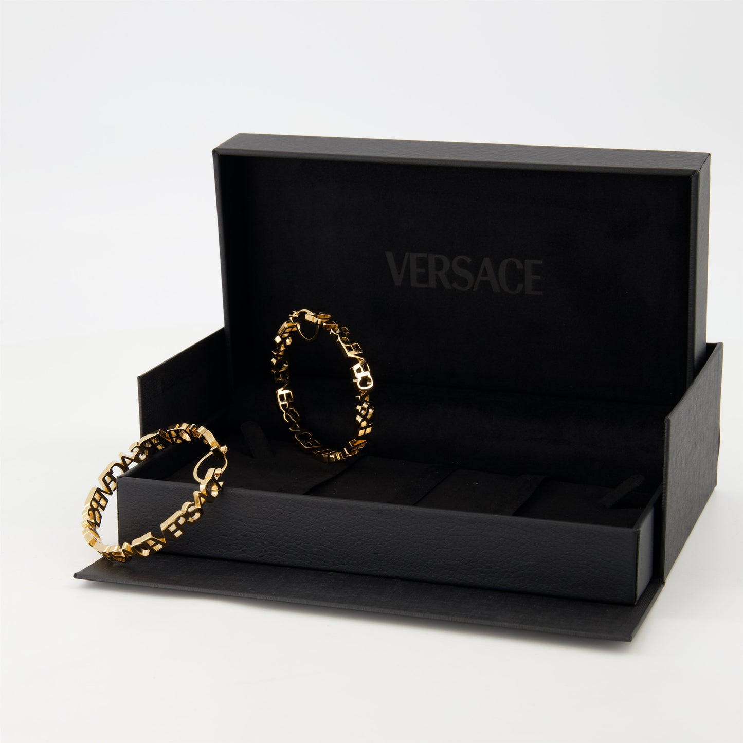 Gold hoop earrings, Versace jewelry, logo earrings, statement accessories, luxury earrings