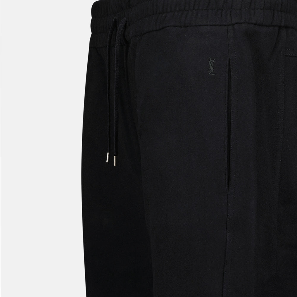 Image of Black Cotton Jogger Pants by Saint Laurent for Men - Season Autumn-Winter 2024 - Detail View 1