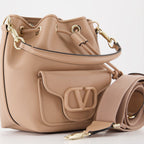   
Pink bucket bag, luxury handbag, Valentino Garavani bag, leather bucket bag, elegant accessories  
