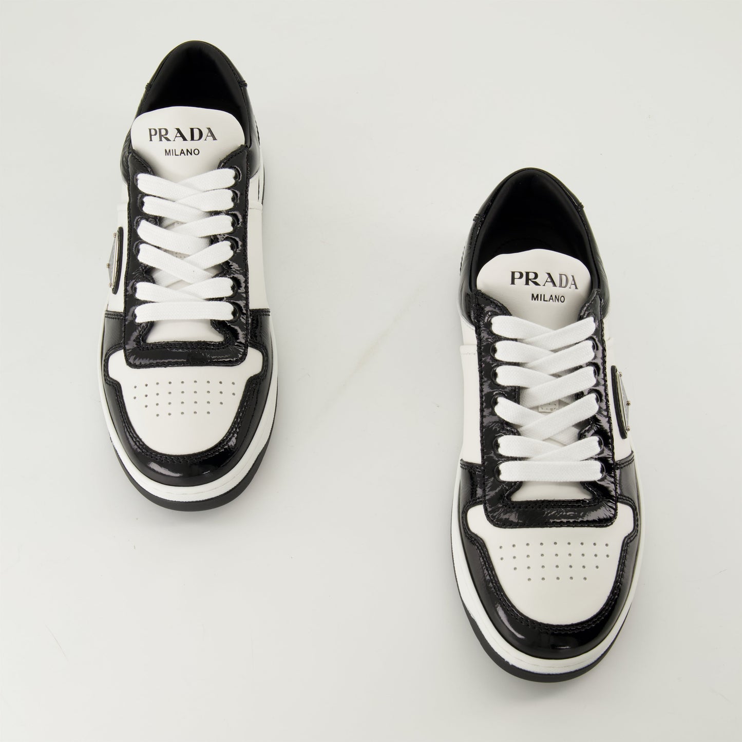 black patent sneakers, geometric tread pattern, lace-up design, removable leather insole, two-tone sneakers