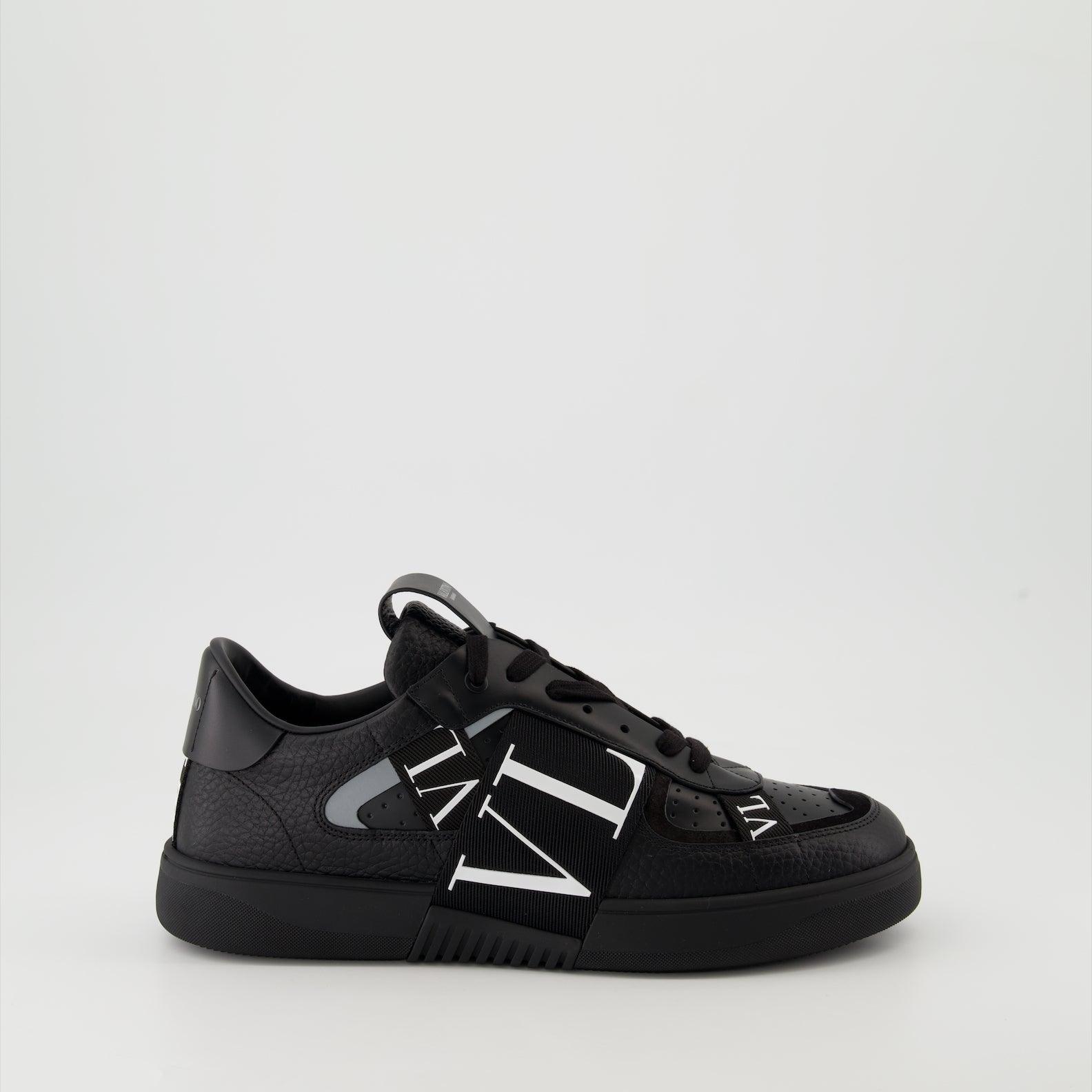 Valentino Garavani sneakers, black leather sneakers, luxury men's footwear, Autumn-Winter 2024 collection, premium grained leather