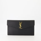 black pouch, grained leather, magnetic closure, Saint Laurent, Cassandre logo