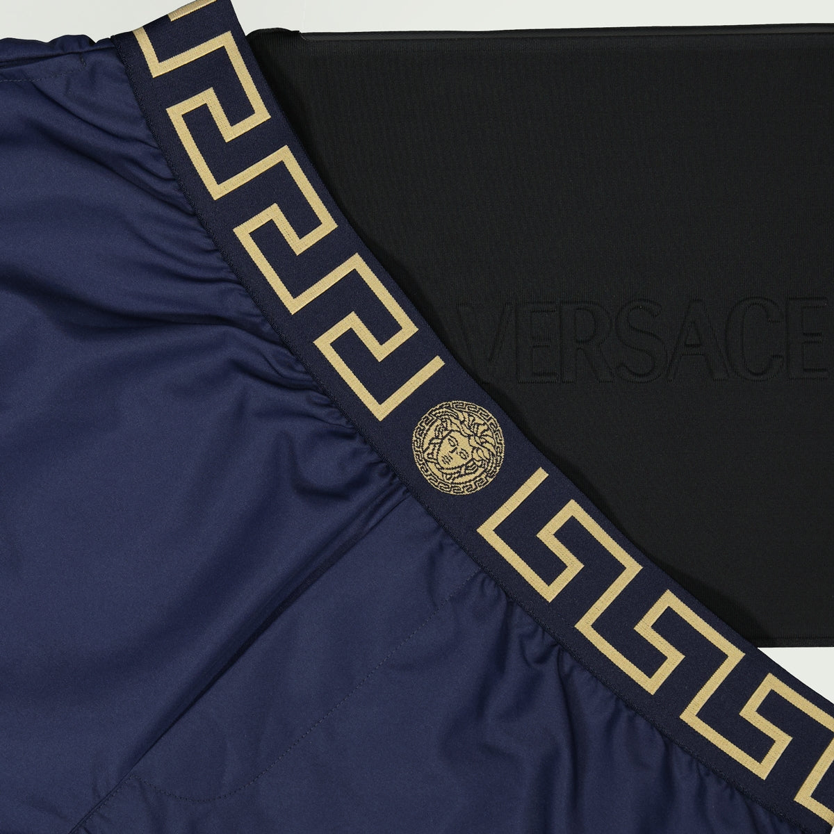 Versace swim shorts, Greca motif shorts, recycled swimwear, eco-friendly fashion, luxury beachwear