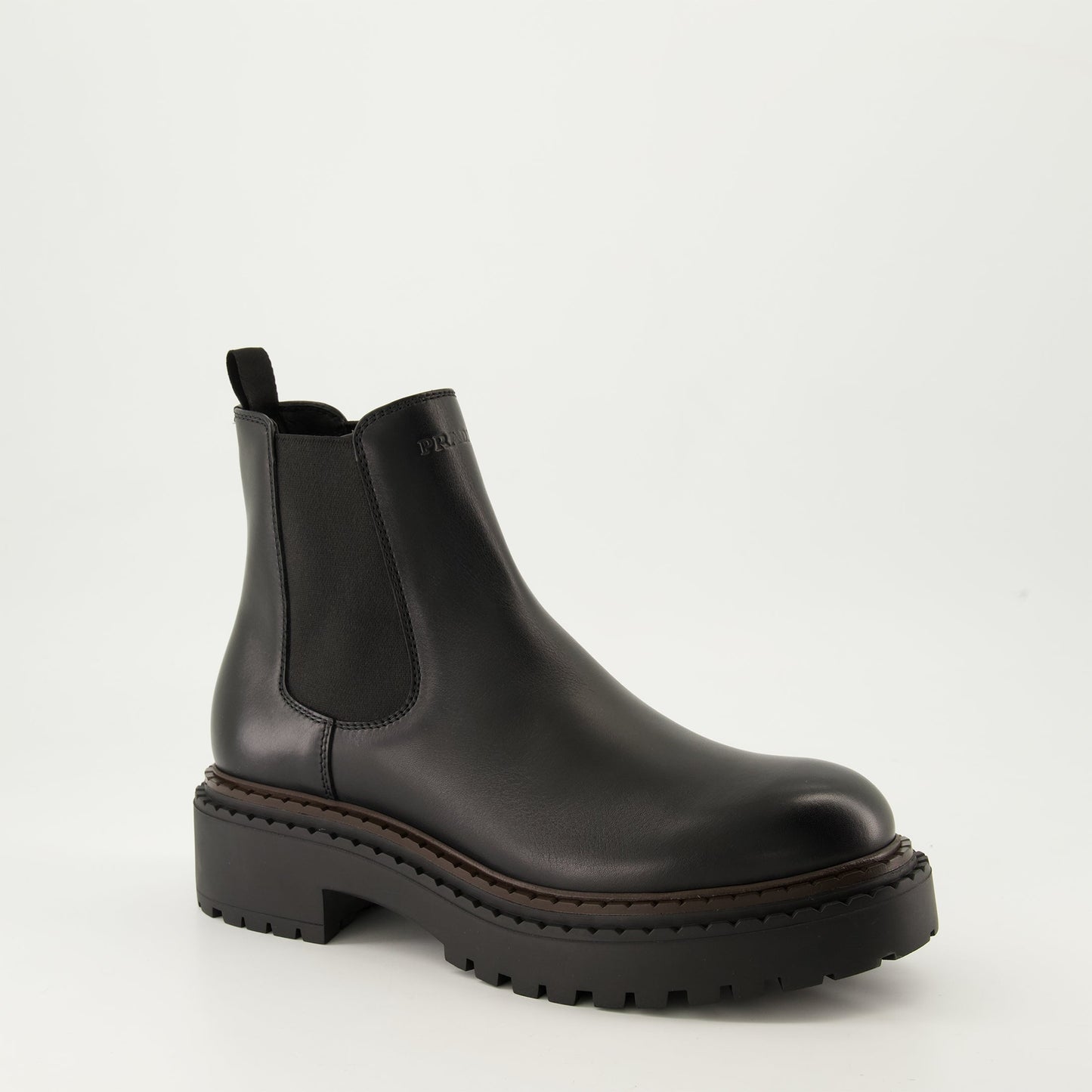 black leather boots, slip-on boots, embossed logo, textured sole, elastic panels