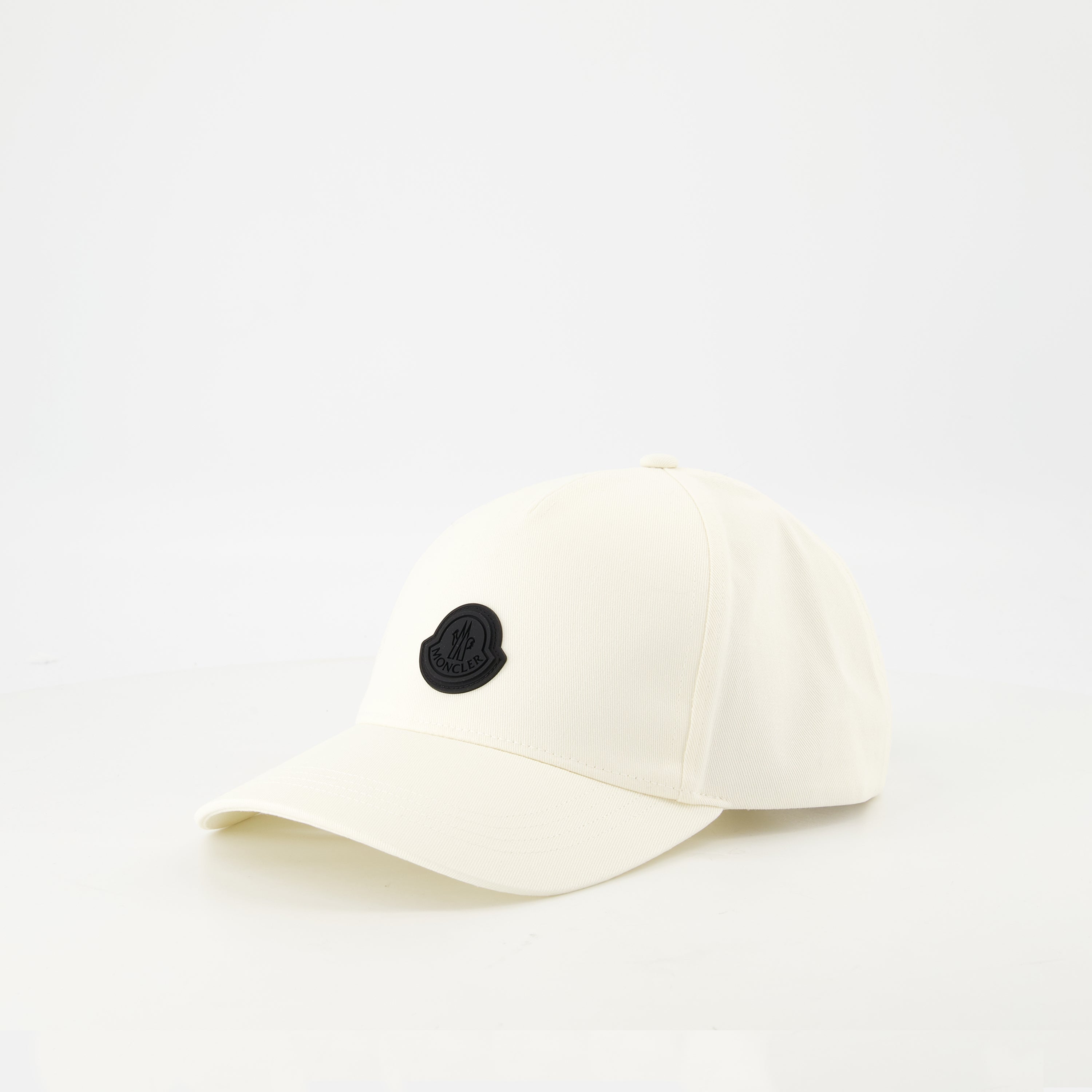 white cap, black logo, adjustable strap, high-quality cotton, contemporary design