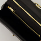 Black leather bag, VLogo design, Valentino Garavani, turn-lock closure, elegant handbag