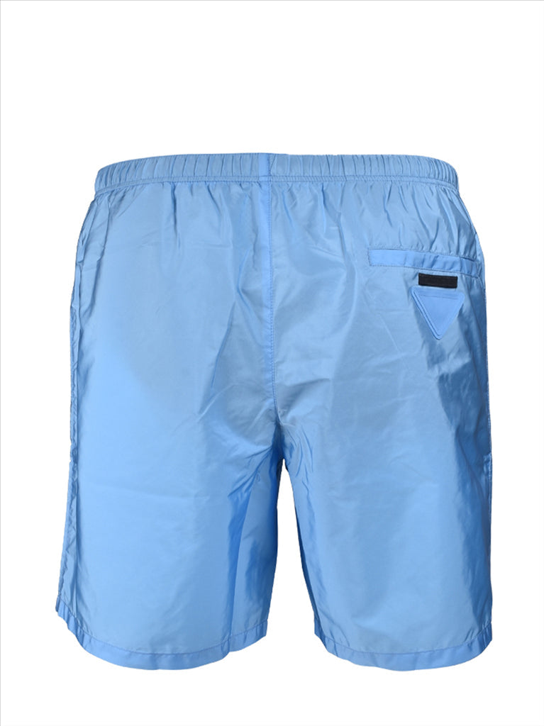 Prada swim trunks, luxury swimwear, men's blue trunks, designer swimwear, high-end summer fashion