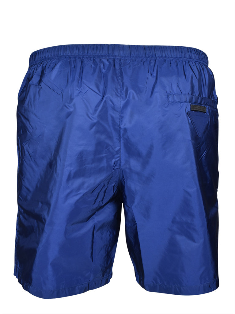 Prada swim trunks, luxury men's swimwear, blue swim shorts, high-end beachwear, designer swimwear