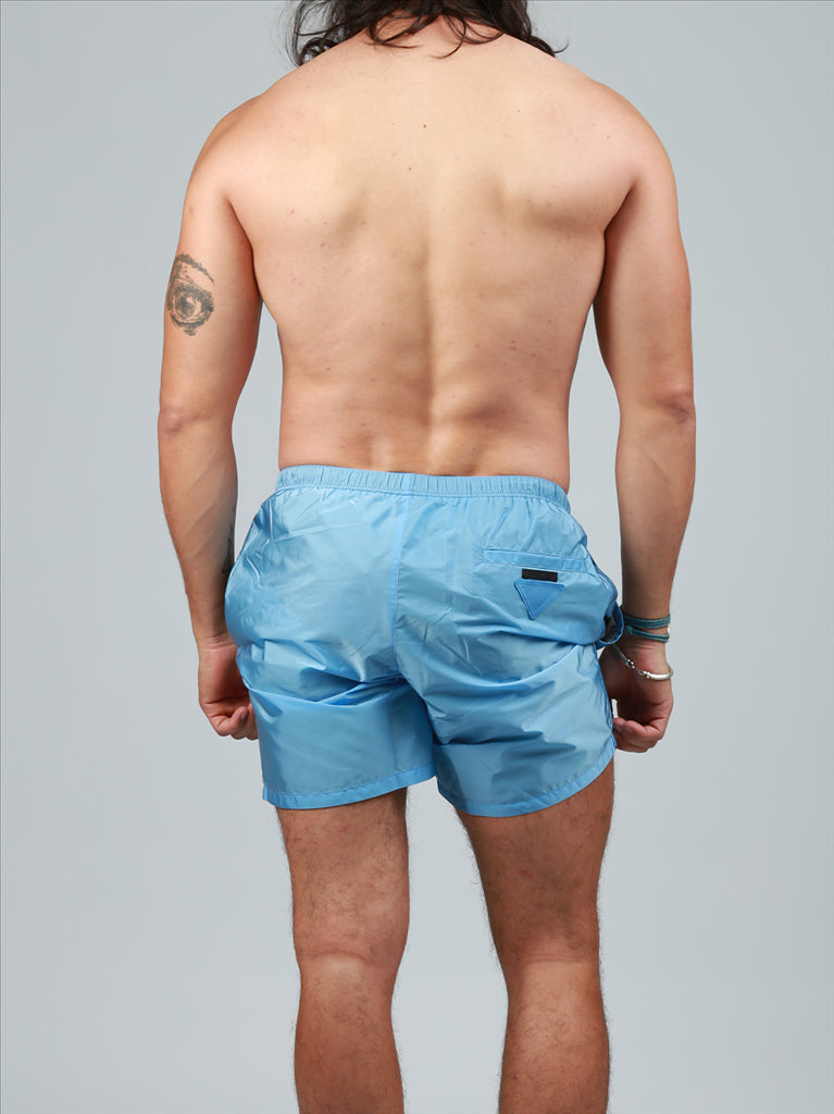 Prada swim trunks, luxury swimwear, men's blue trunks, designer swimwear, high-end summer fashion