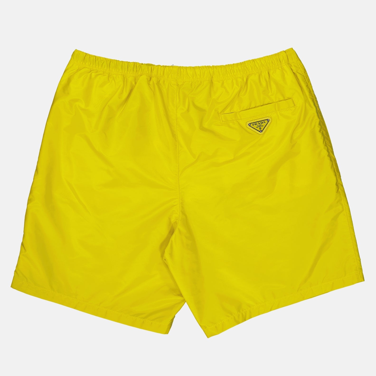 Prada swim shorts, Re-Nylon swimwear, luxury men's swimwear, sustainable beachwear, yellow swim trunks