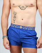 Versace swim trunks, luxury swimwear, Medusa pattern, men's designer swimwear, blue swim trunks