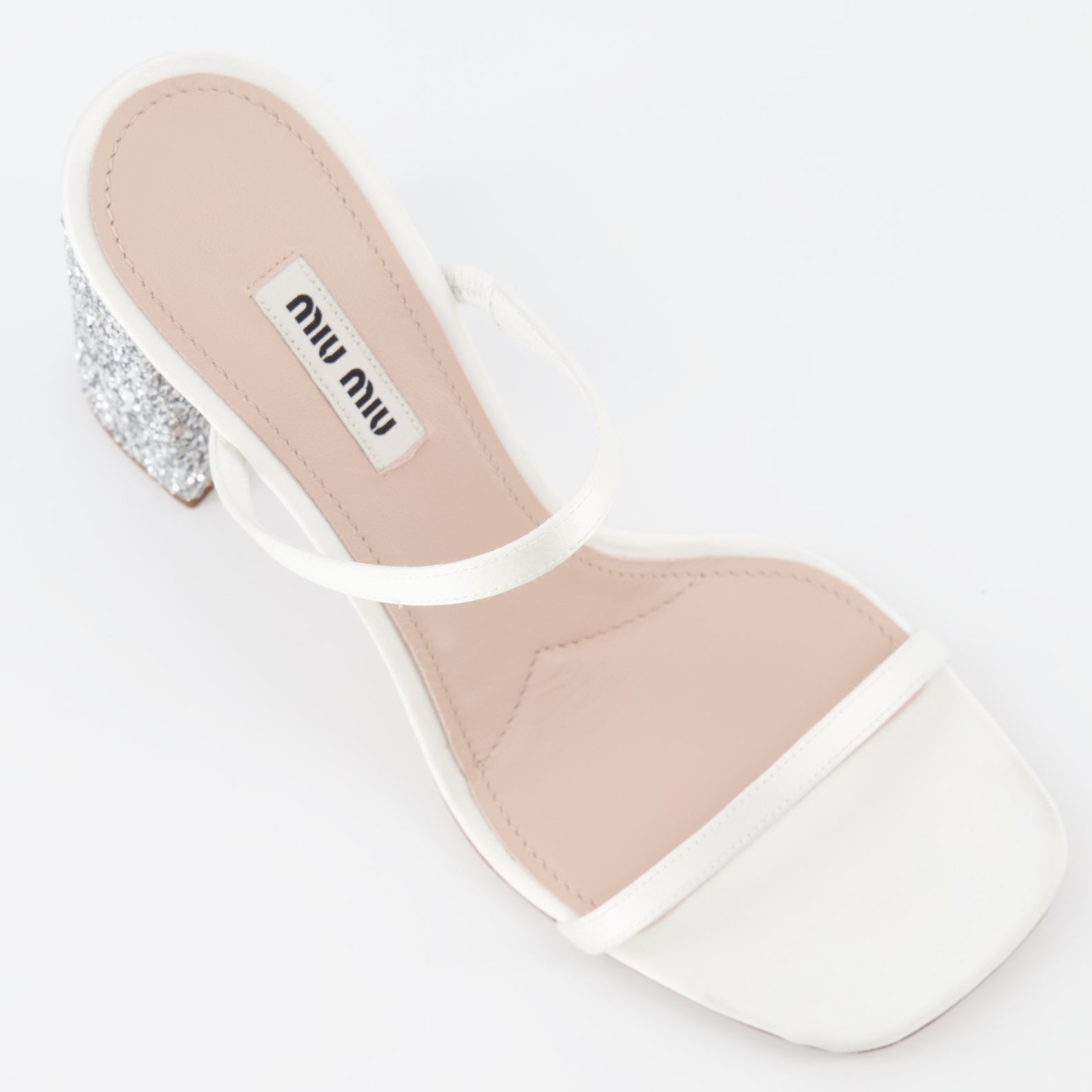 Miu Miu glitter mules, luxury white mules, women’s sparkling shoes, elegant designer footwear, glamorous mules