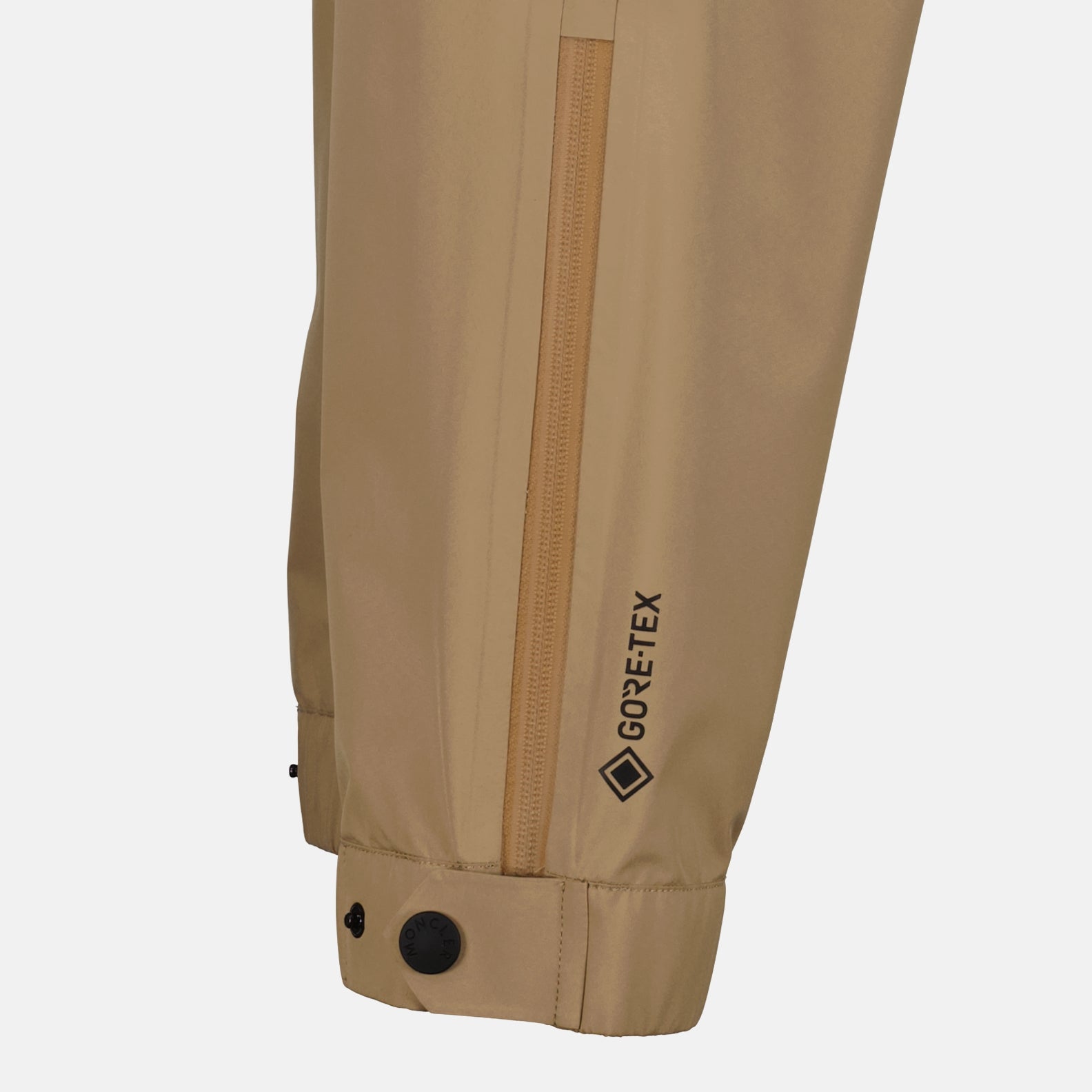  
Moncler Grenoble ski pants, luxury ski wear, beige ski pants, men's ski pants, high-end ski apparel  
**