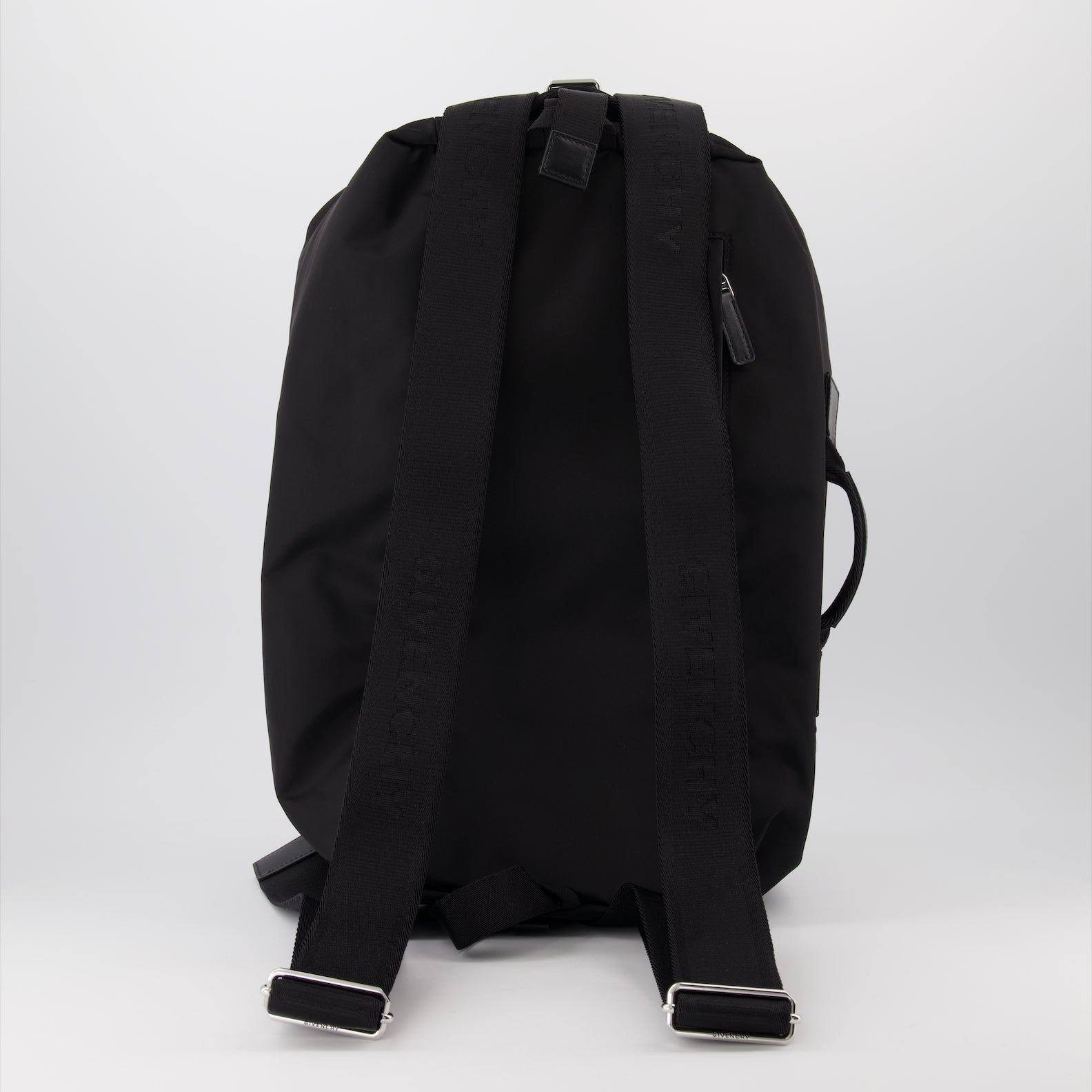 nylon backpack, adjustable straps, leather accents, front zip closure, silver-tone details